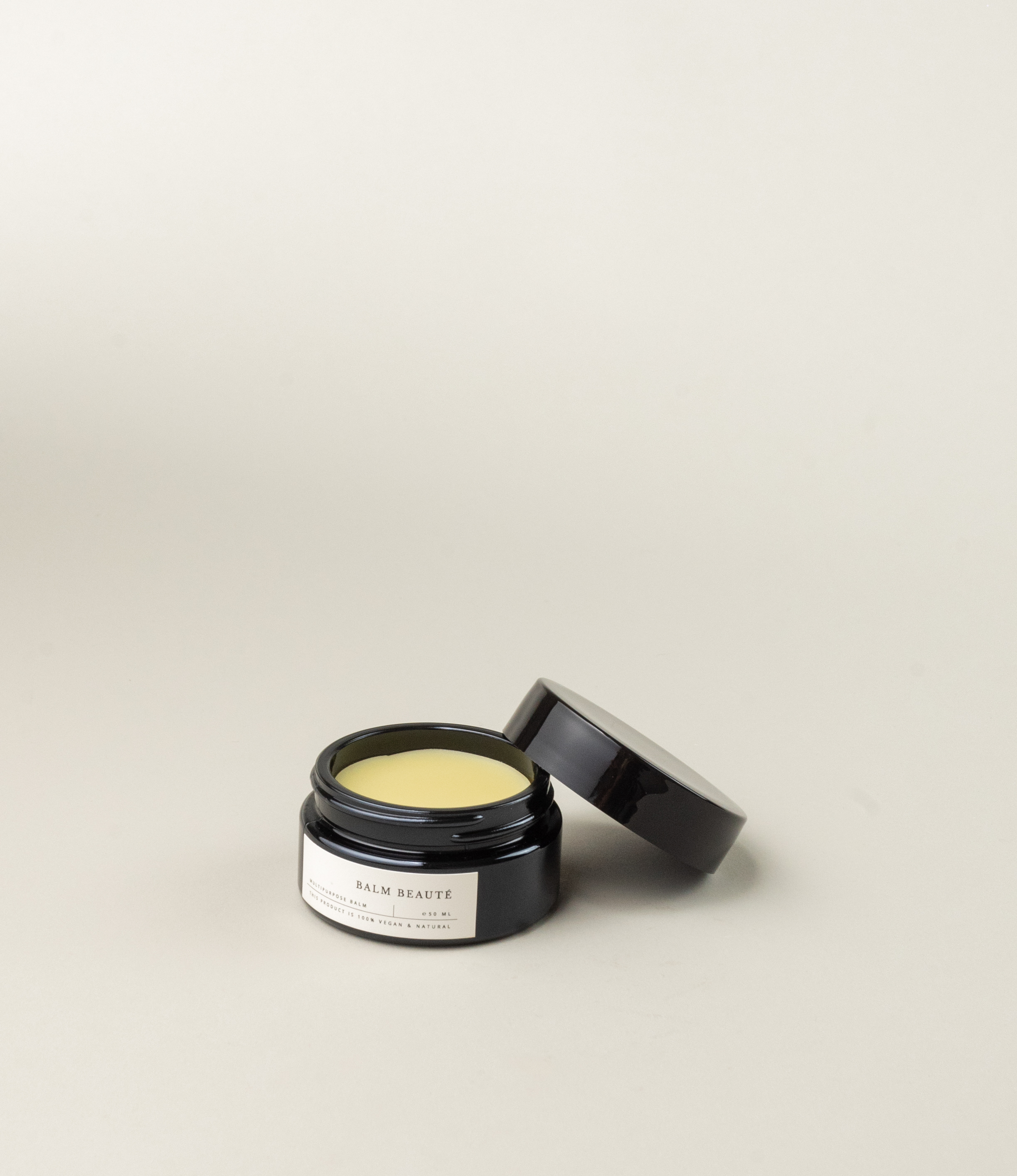 Multipurpose balm from Azur Natural Body Care. The balm comes in a black elegant tin. The balm itself has a pale vanilla color.