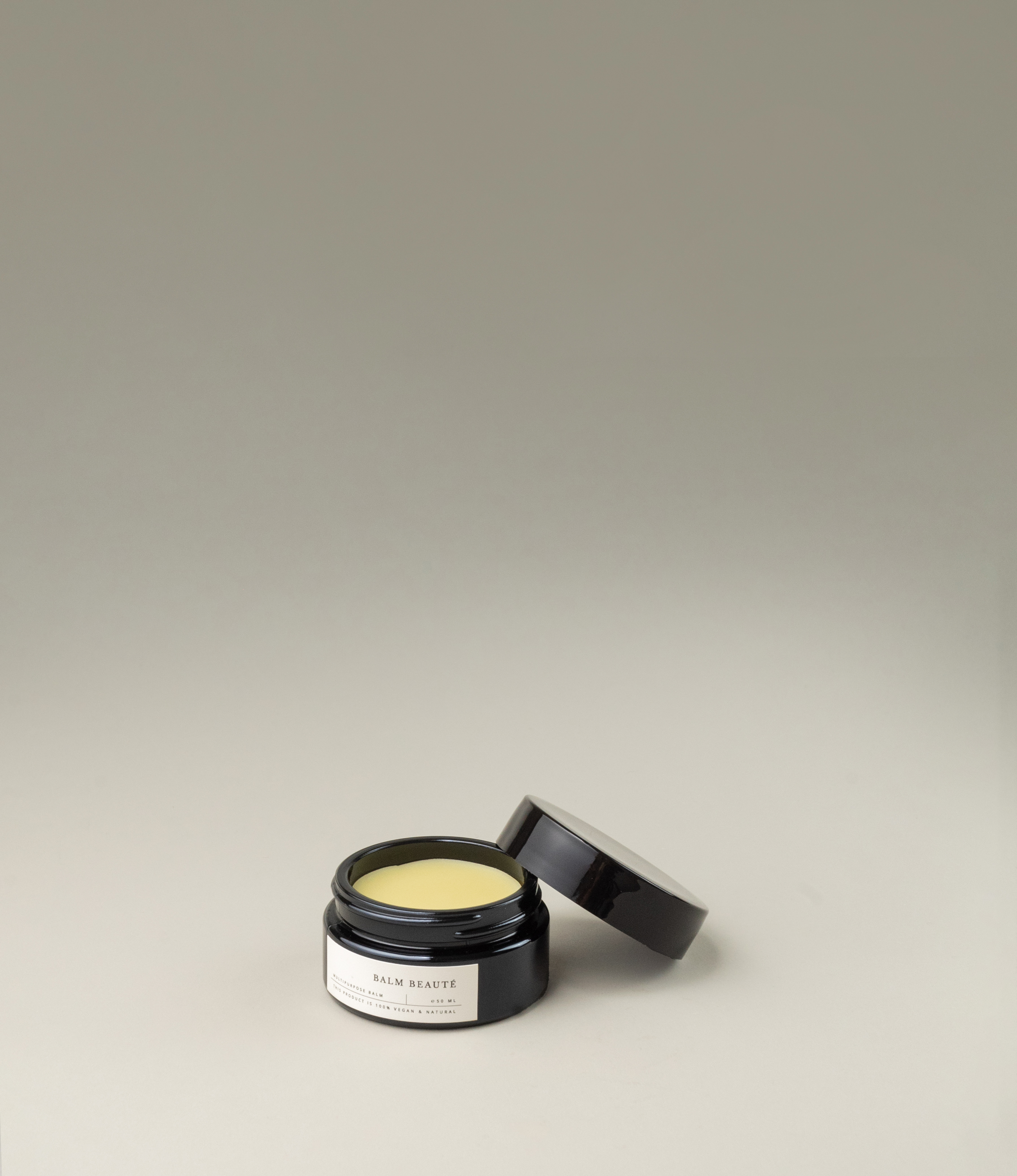 Multipurpose balm from Azur Natural Body Care. The balm comes in a black elegant tin. The balm itself has a pale vanilla color.