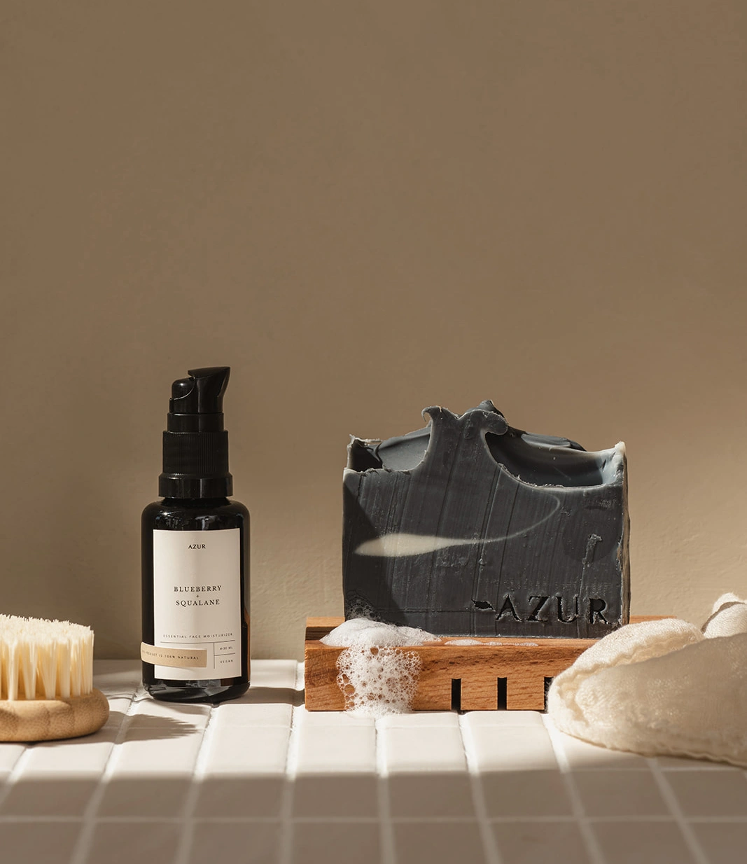 Azur Face Cleansing Soap In use with wooden soap tray. There is the face oil next to the product also.