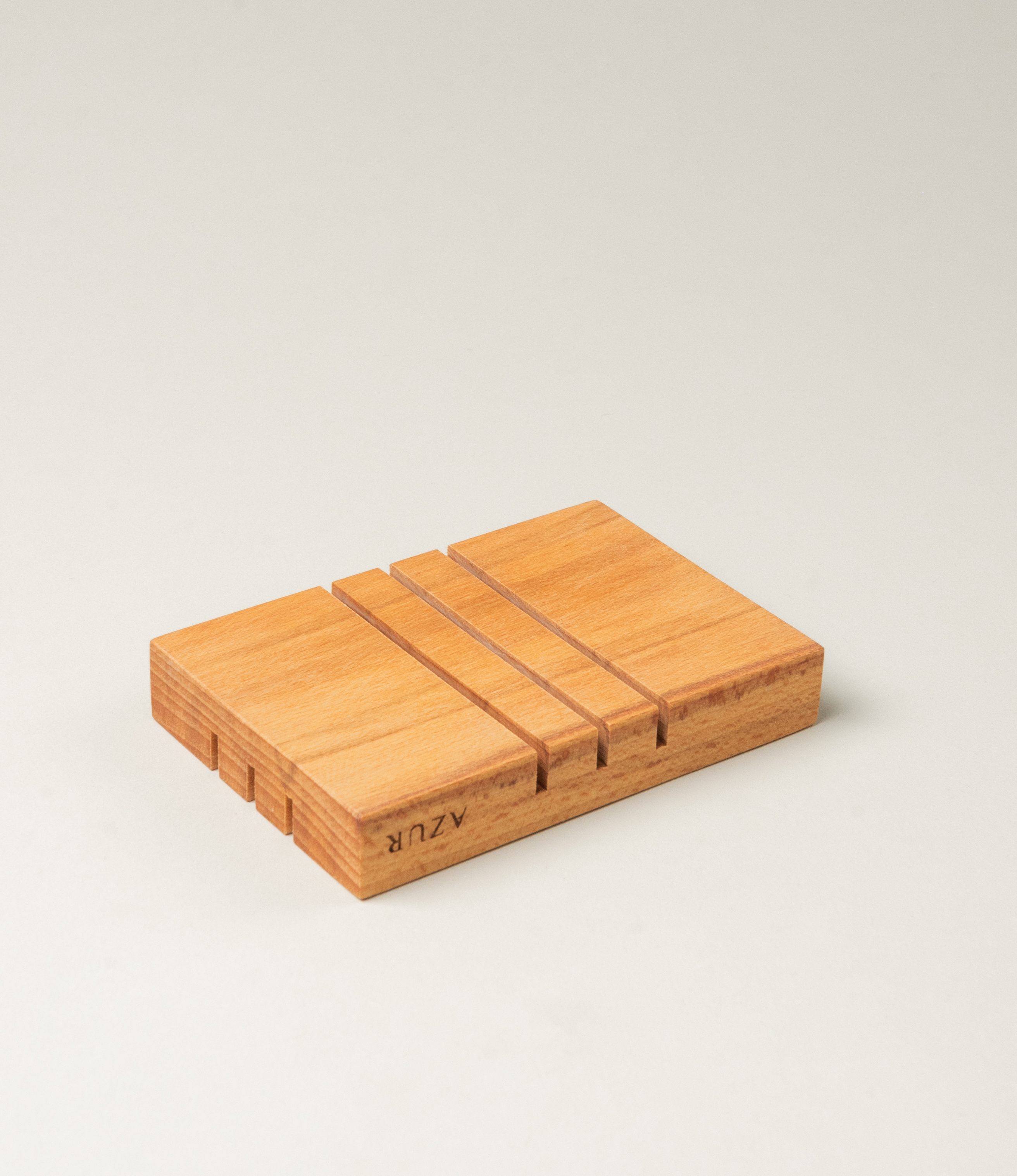 Wooden Soap tray from Azur Natural Bodycare. The item evokes the japanese minimalism with its simple yet sophisticated shape. The Tray has three split on it on both sides, but on the different direction.