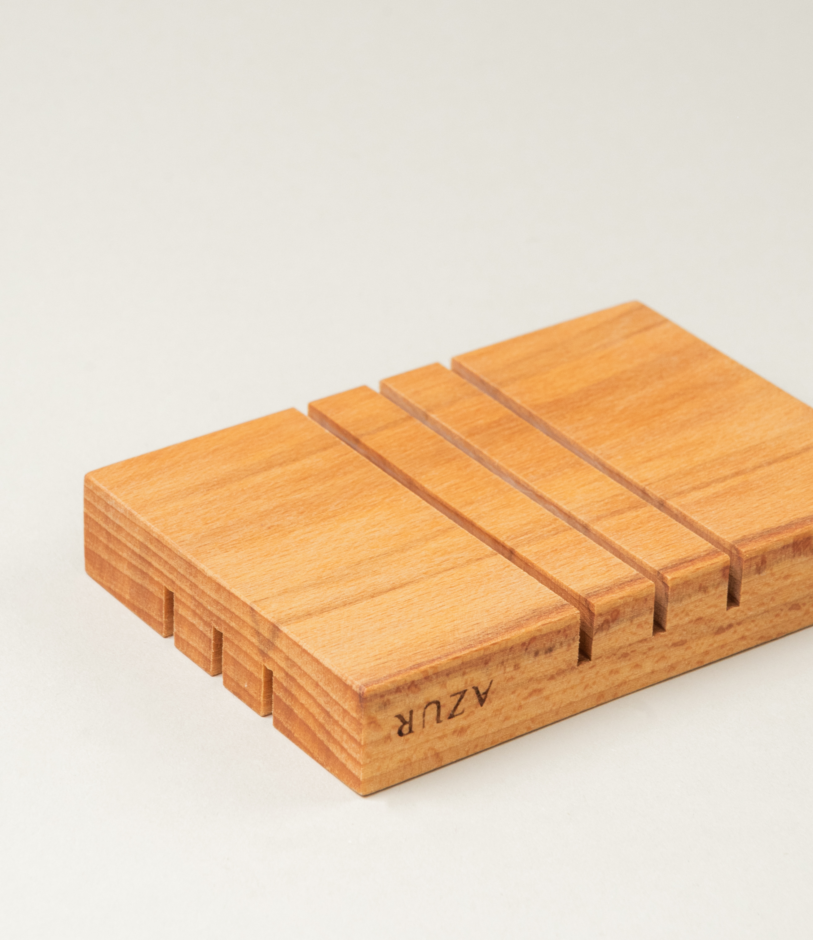 Wooden Soap tray from Azur Natural Bodycare. The item evokes the japanese minimalism with its simple yet sophisticated shape. The Tray has three split on it on both sides, but on the different direction.