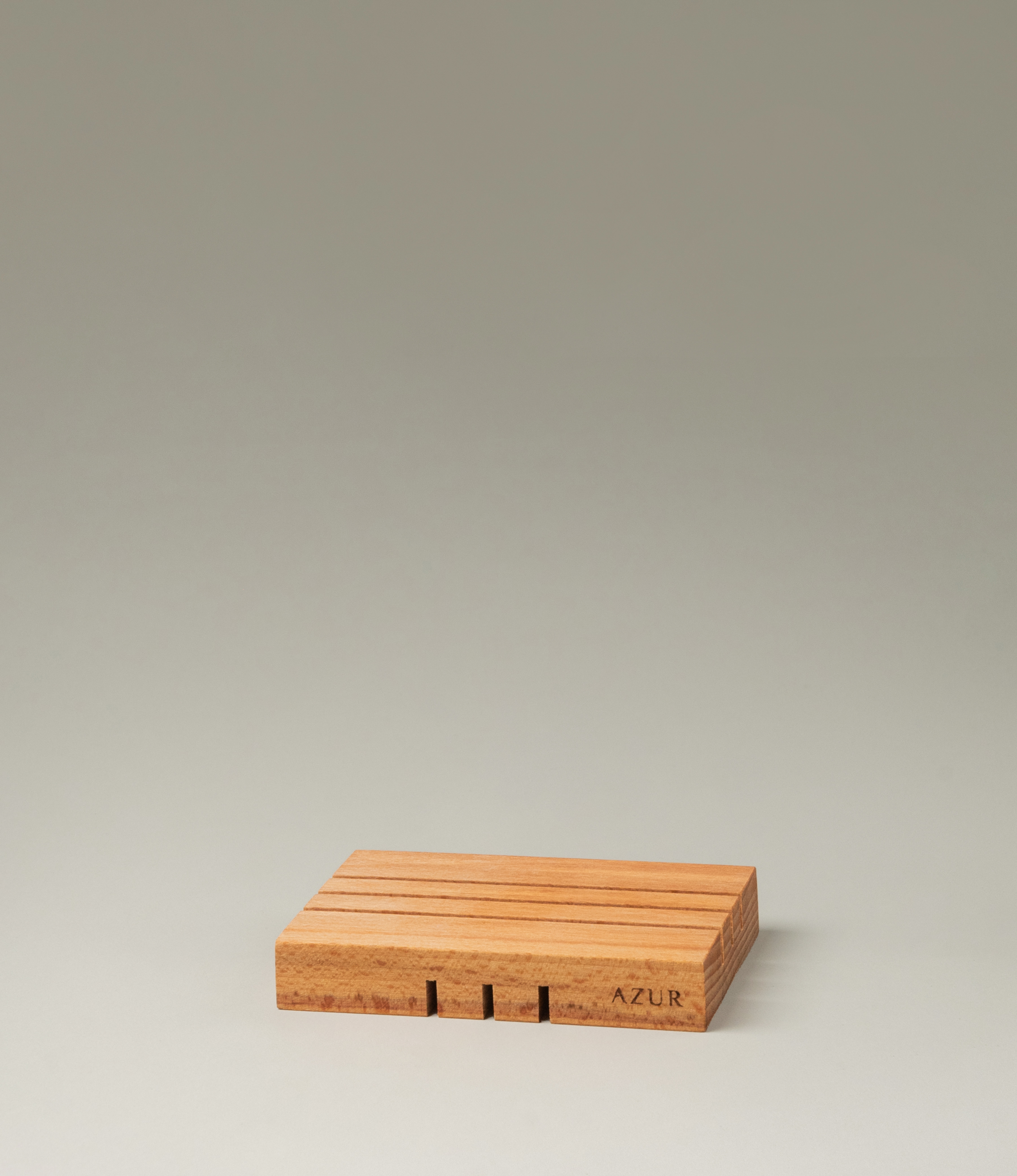 Wooden Soap tray from Azur Natural Bodycare. The item evokes the japanese minimalism with its simple yet sophisticated shape. The Tray has three split on it on both sides, but on the different direction.