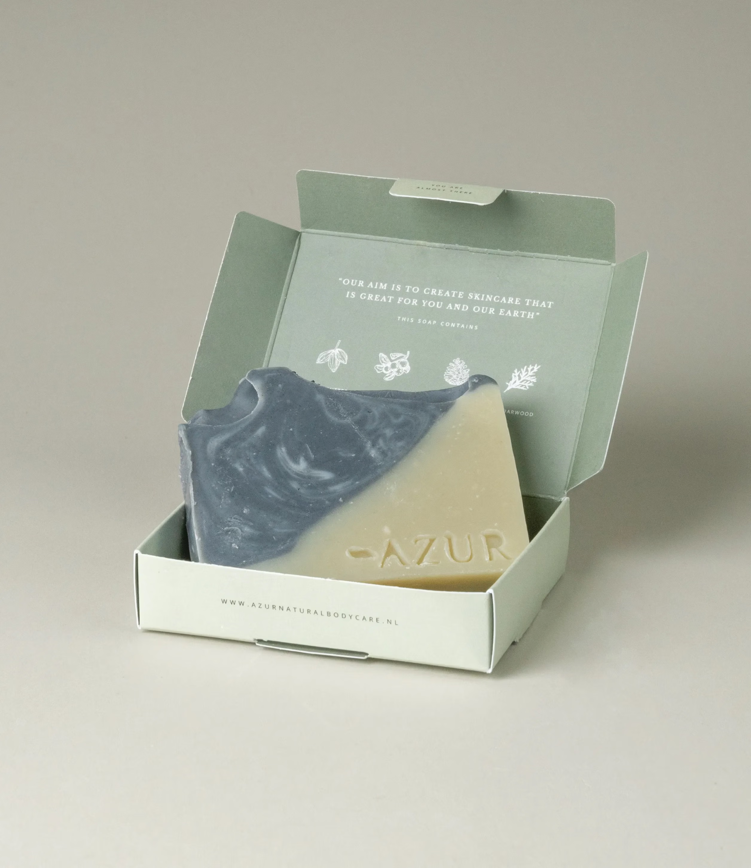 This soap has the scent of Wild Woods and it was crafted by Azur Natural Bodycare. The product merges two colors, light olive and dark grey. The top of the soap looks like the waves of the ocean.