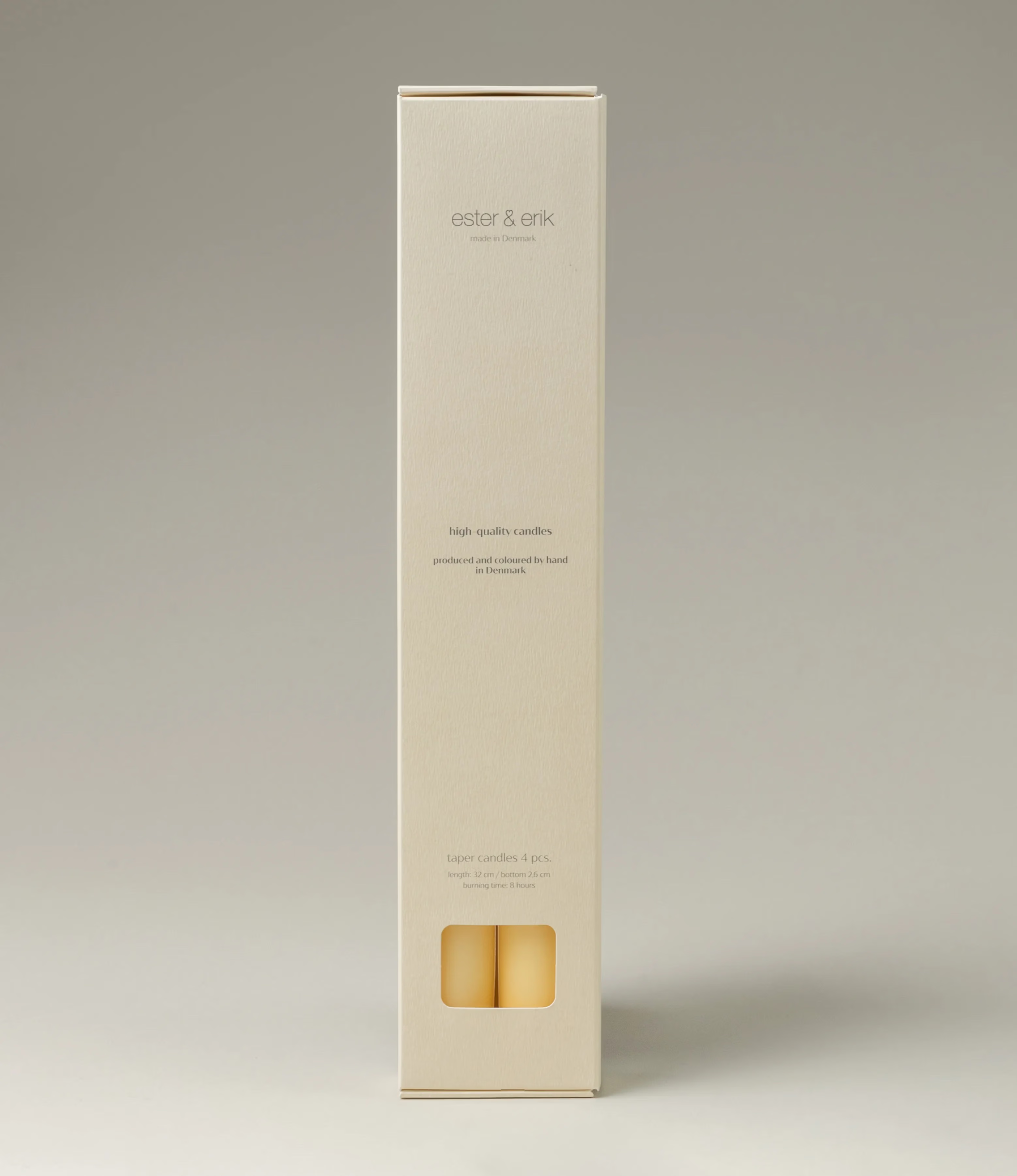 Ester&Erik Taper Candle coming in a Buttermilk shade. The package contains 4 taper candles of the same shade. The packaging has a warm white color, and elegant minimalistic design.