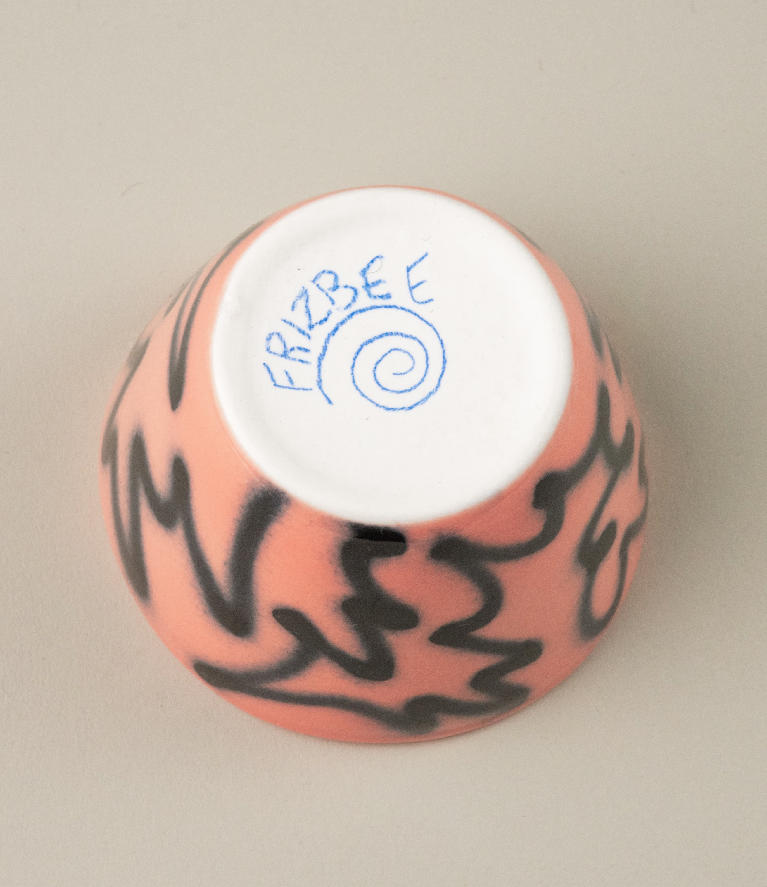 Super Cup from Frizbee Ceramics is a set of two cups. The bottom of the cup has the hand drawn logo of Frizbee Ceramics.