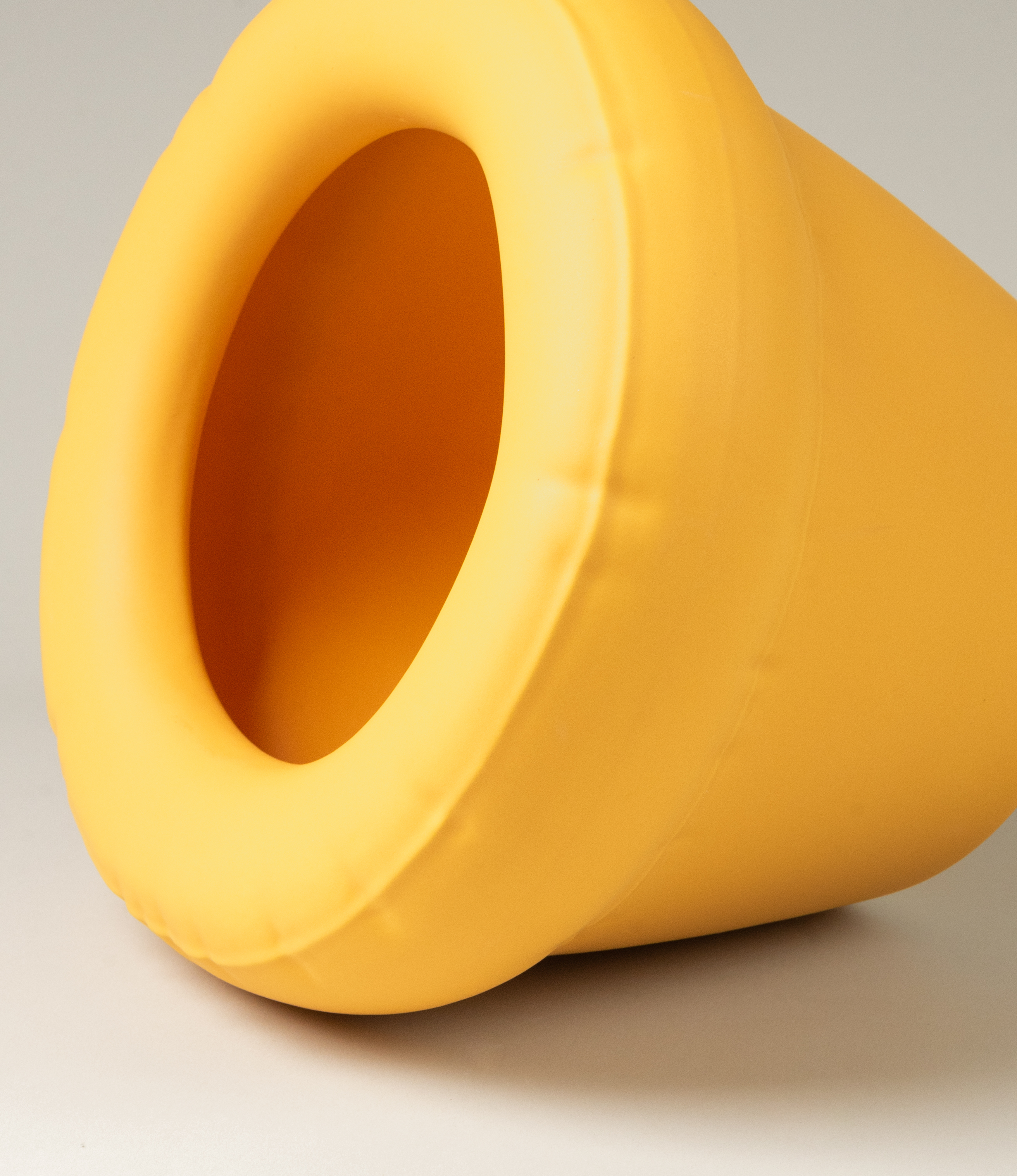 Homestudyo planter pierre in Yolk (yellow) color. The perpective of the shot is a zoom. the planter design looks like and inflatable ballon although it is made of ceramics. Perfect addition for any maximalist interior