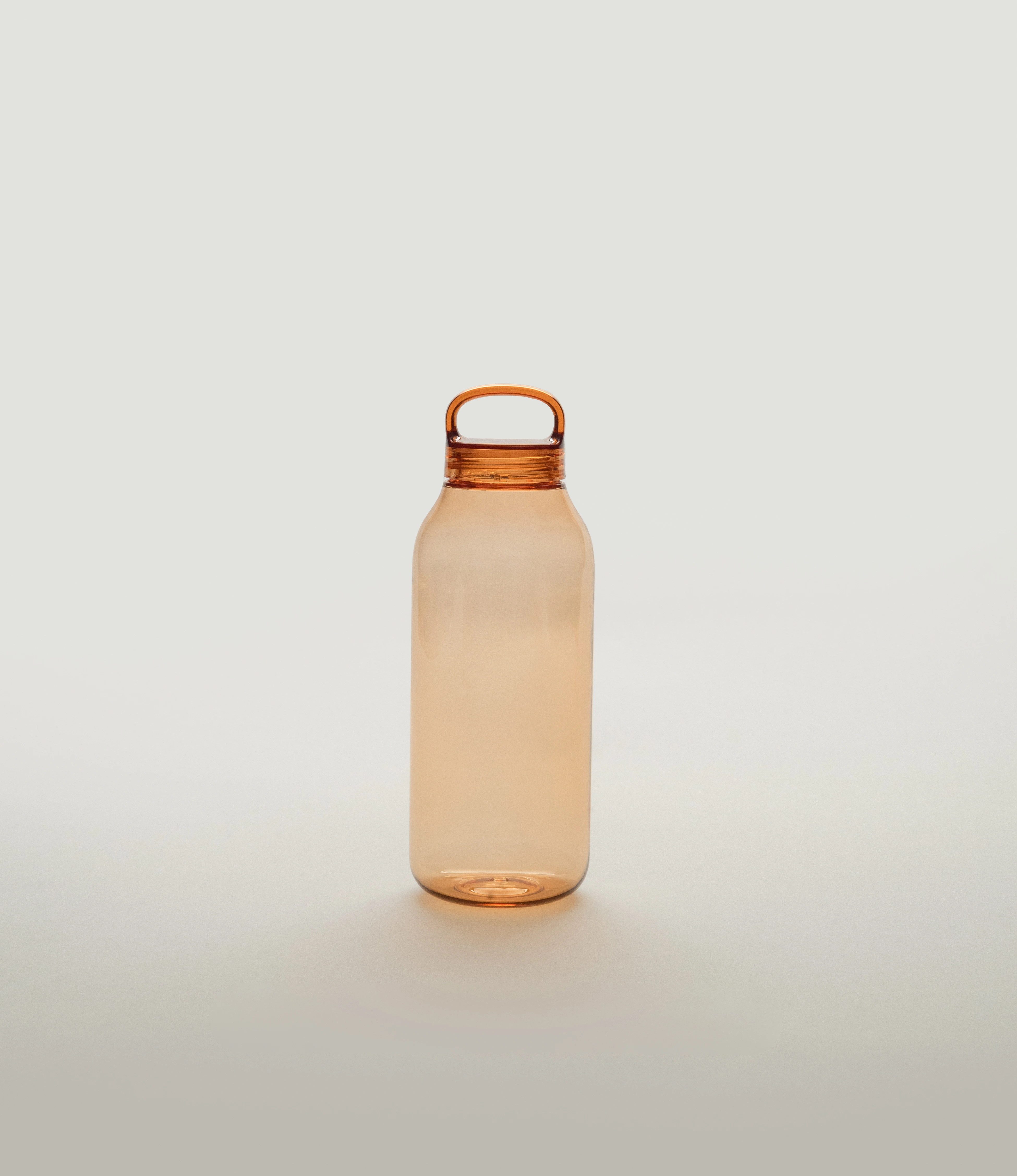 A sleek amber-colored water bottle with a minimalist design and a rounded handle integrated into the cap. The bottle sits on a soft neutral background, emphasizing its translucent material and modern aesthetic.