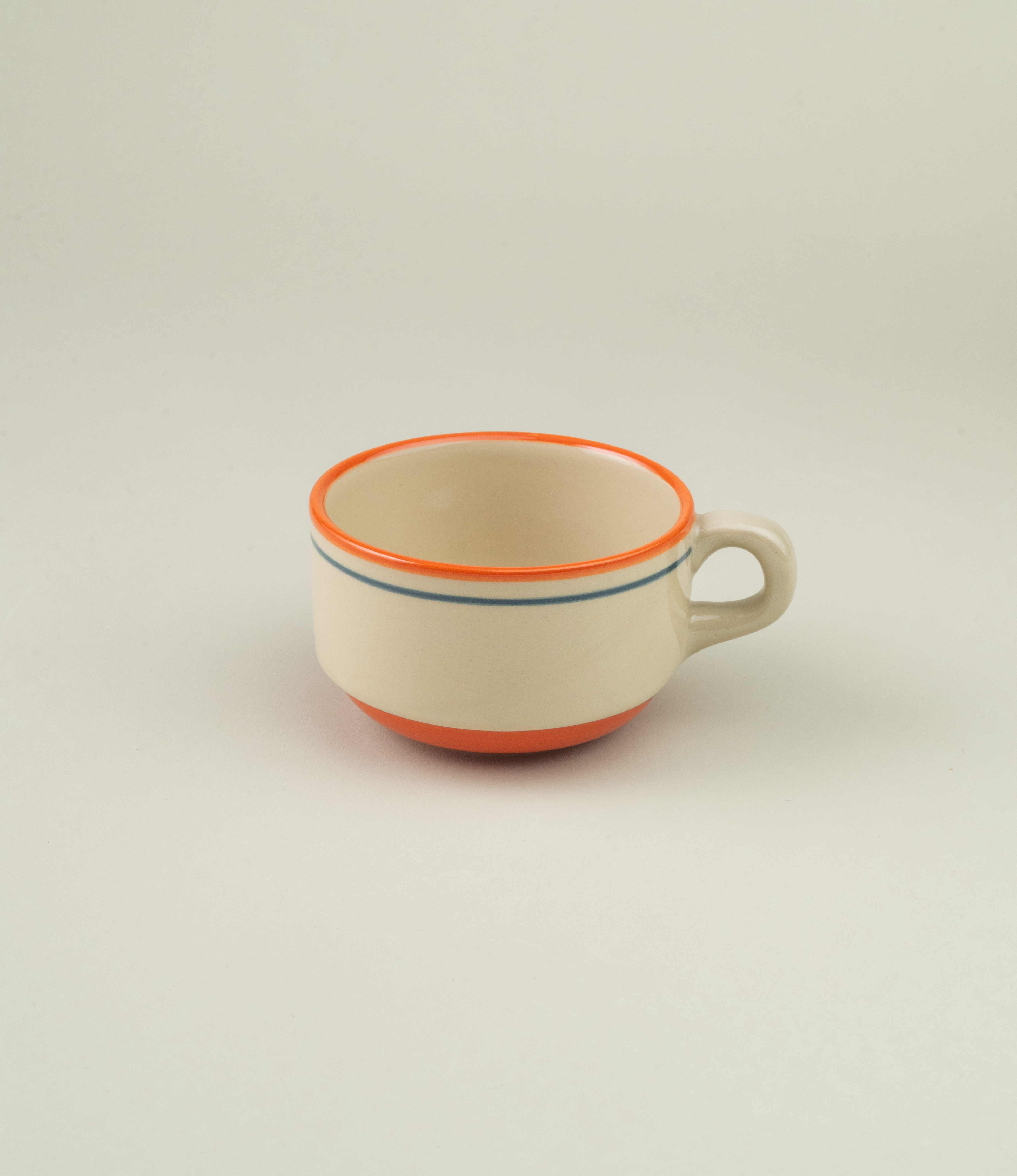 Solo view of the cup without the saucer, focusing on its clean cylindrical shape and dual-line decoration.