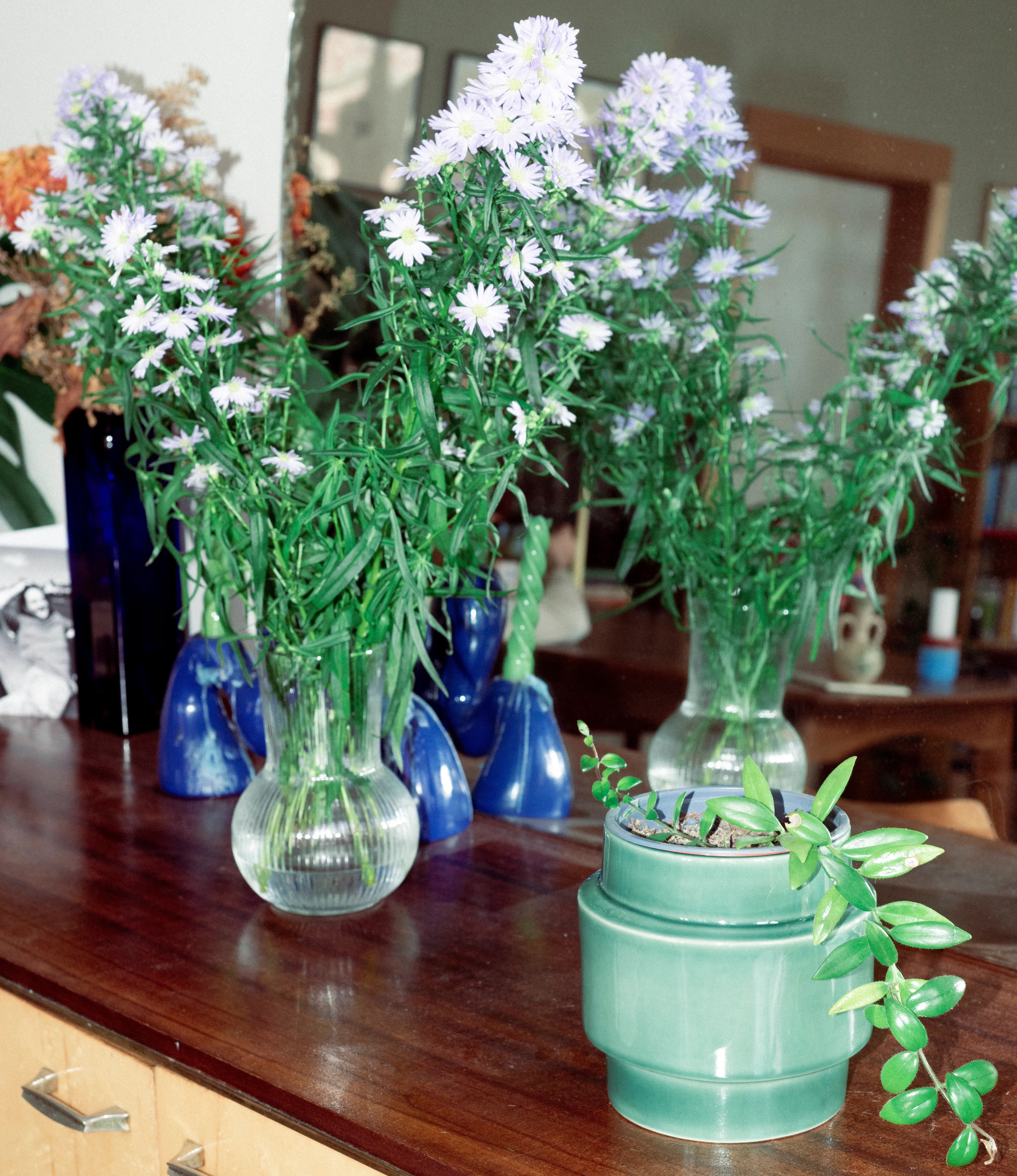 NE Buoy Planter from Nova Casa Atlantica showcased on top of a drawer, with vintage vases and flowers.