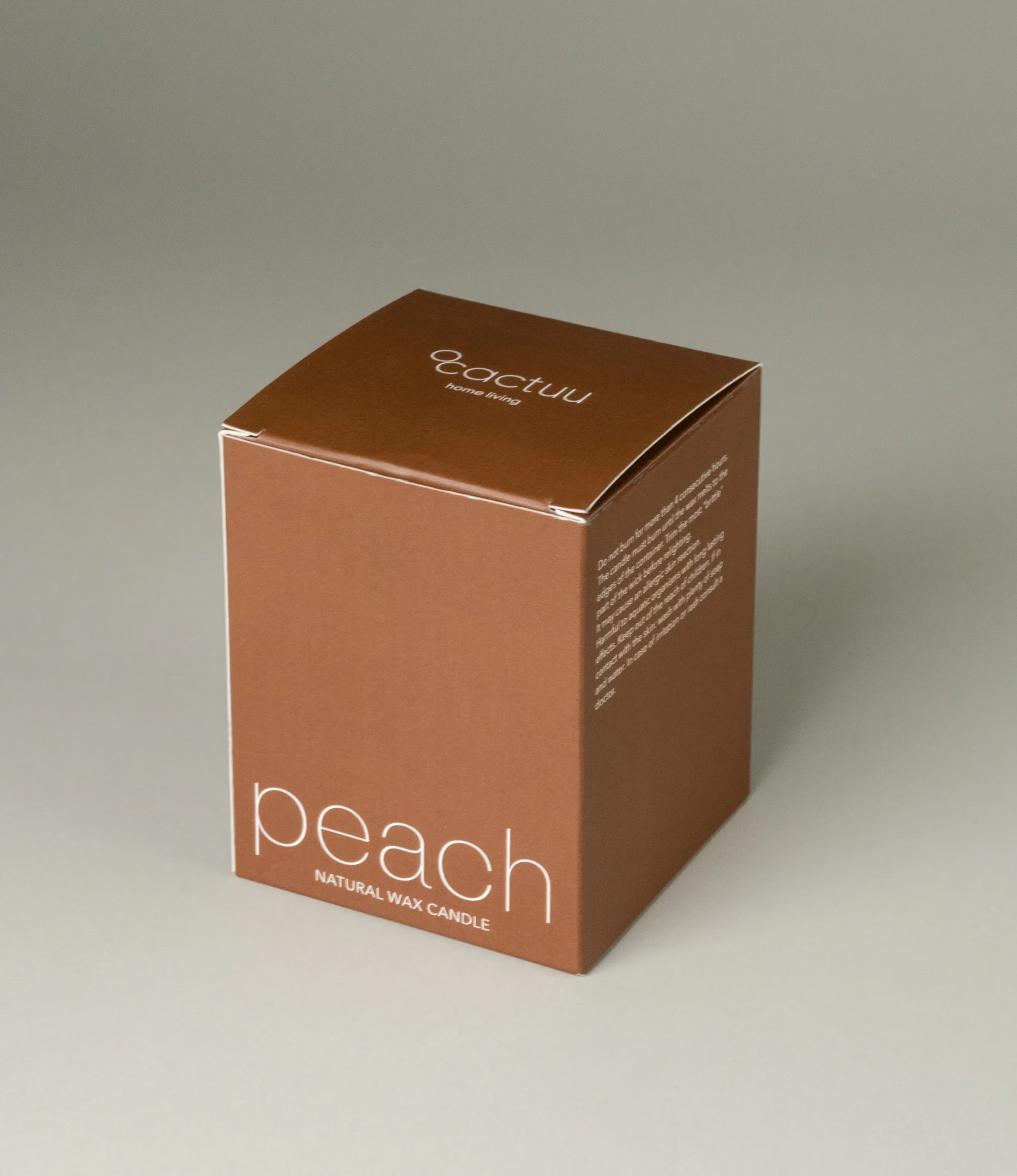 A scented Wax Candle designed by Ocactuu. The candle has an amber scent and it comes in a brown minimal style box. The text is white on the packaging.