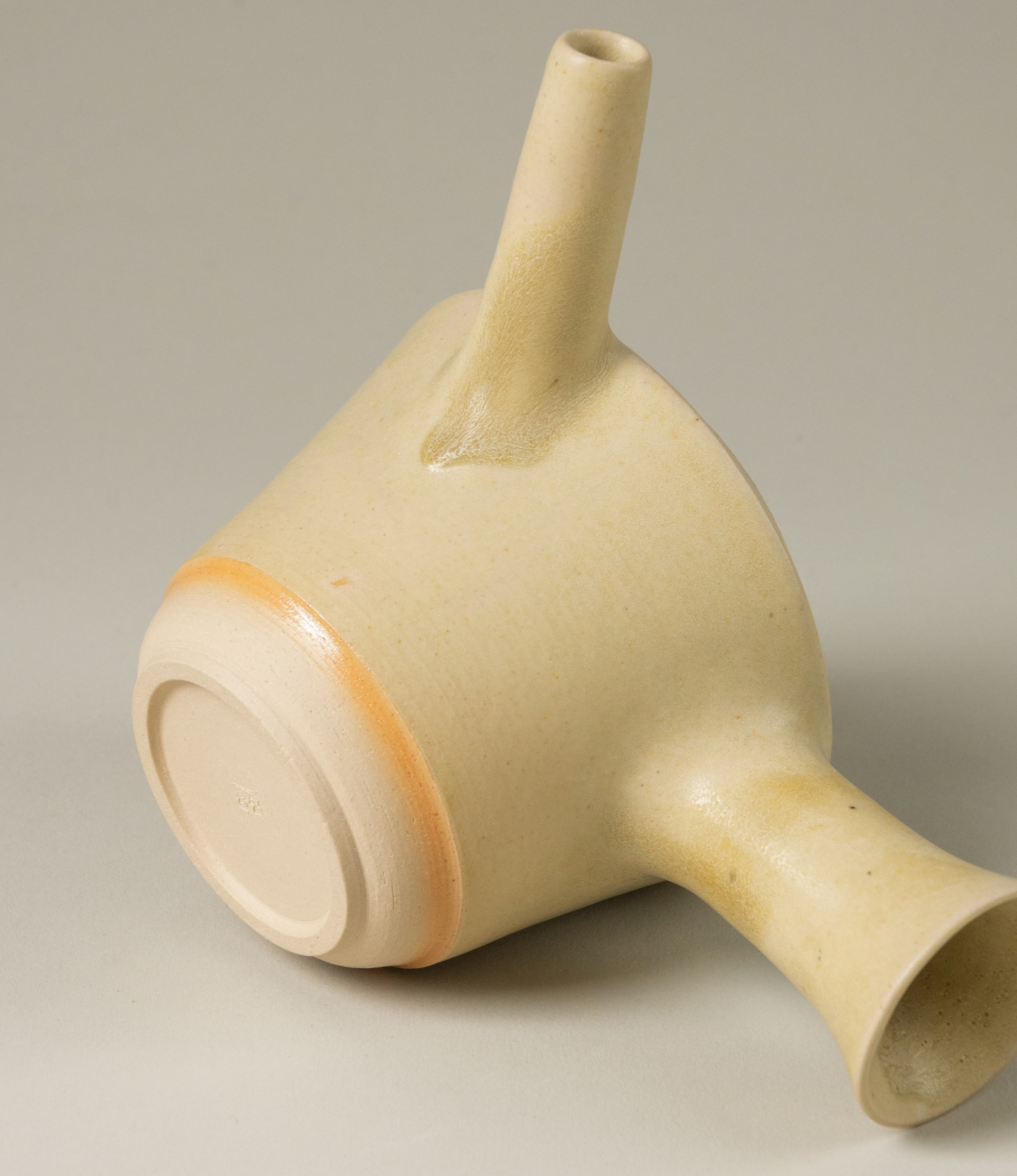 A detail photo of the teapot from Omni Ceramics. You can really feel the human touch on this light beige piece. Handcrafted with an attention to detail.