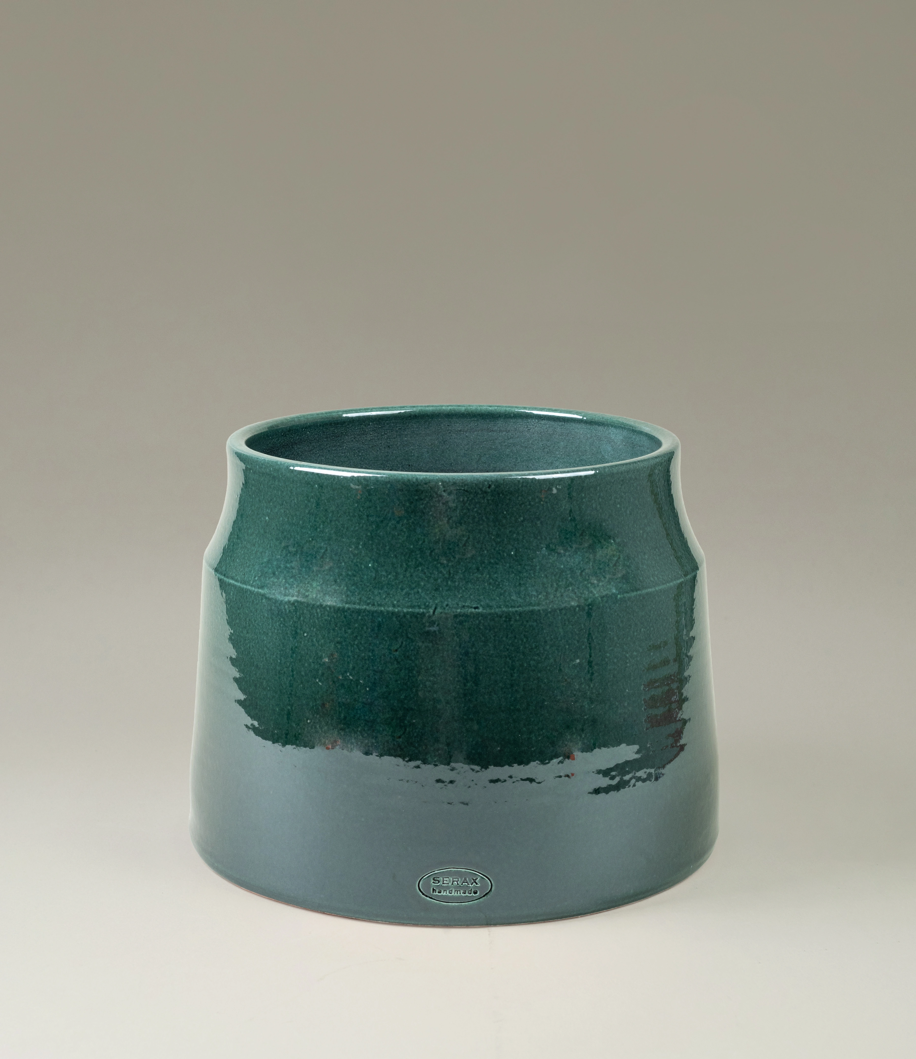 Serax Dark Green Flower Pot in a medium size, featuring a glossy finish with rich emerald tones and a modern tapered design. A timeless piece to showcase your plants in style.