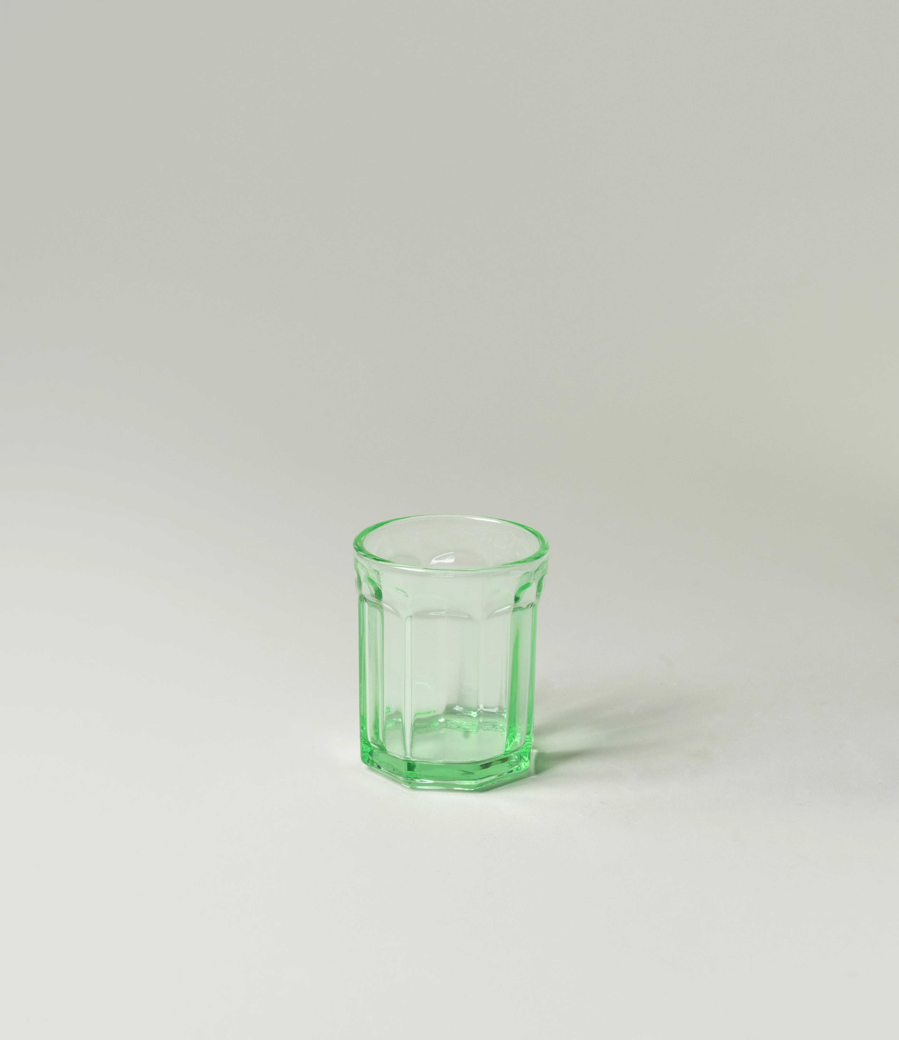 Serax Green Glass Tumbler, showcasing a design with vintage-inspired facets and a vibrant green tone. A versatile and stylish addition to elevate everyday dining.