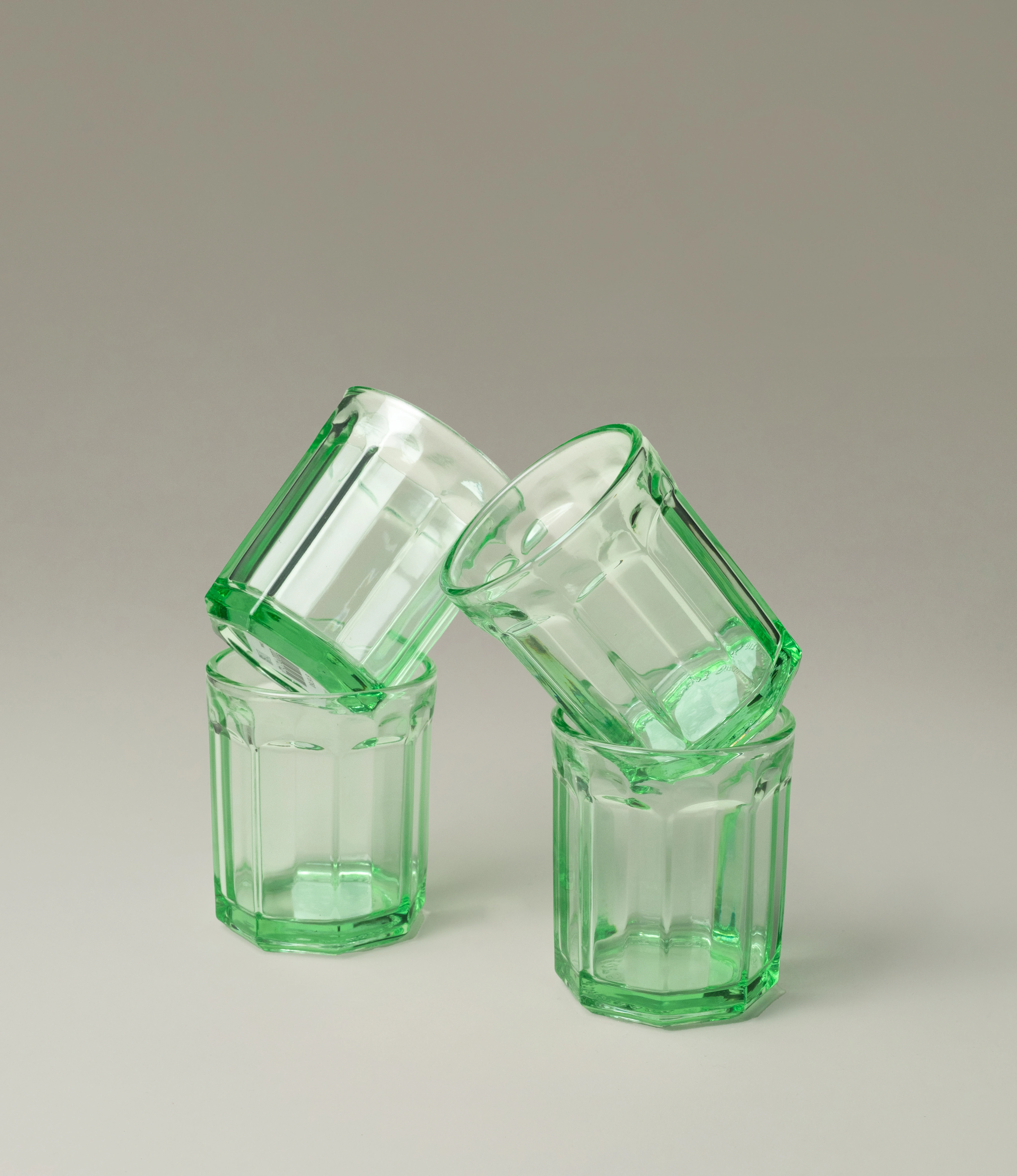 Serax Green Glass Tumblers, a set of glasses with a vintage-inspired faceted design and a vibrant green hue. Ideal for adding a touch of elegance and charm to your table setting.
