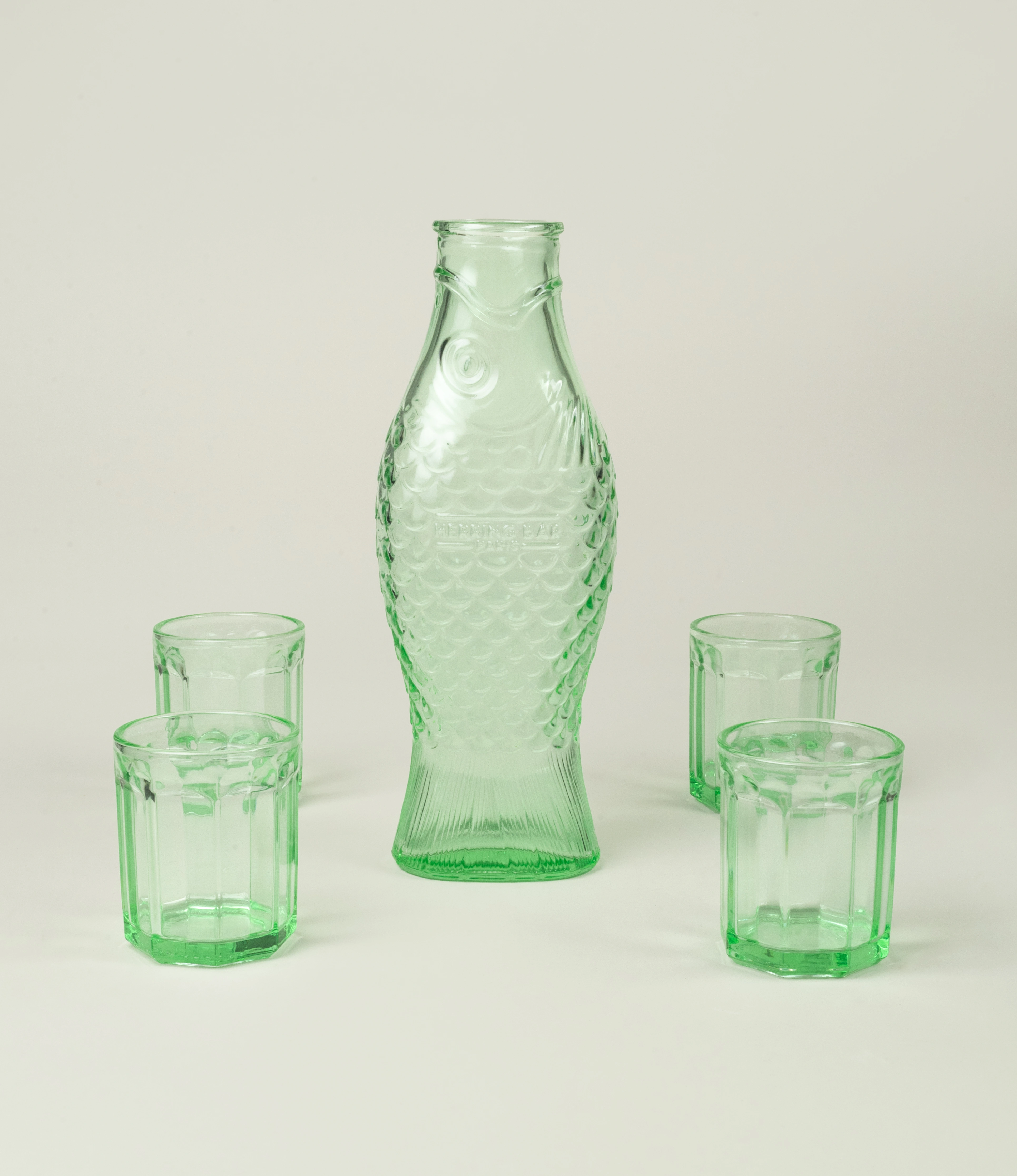 Serax Green Glass Set featuring a fish-shaped glass carafe with textured scales and four green glass tumblers. A playful yet elegant addition to your tableware collection.