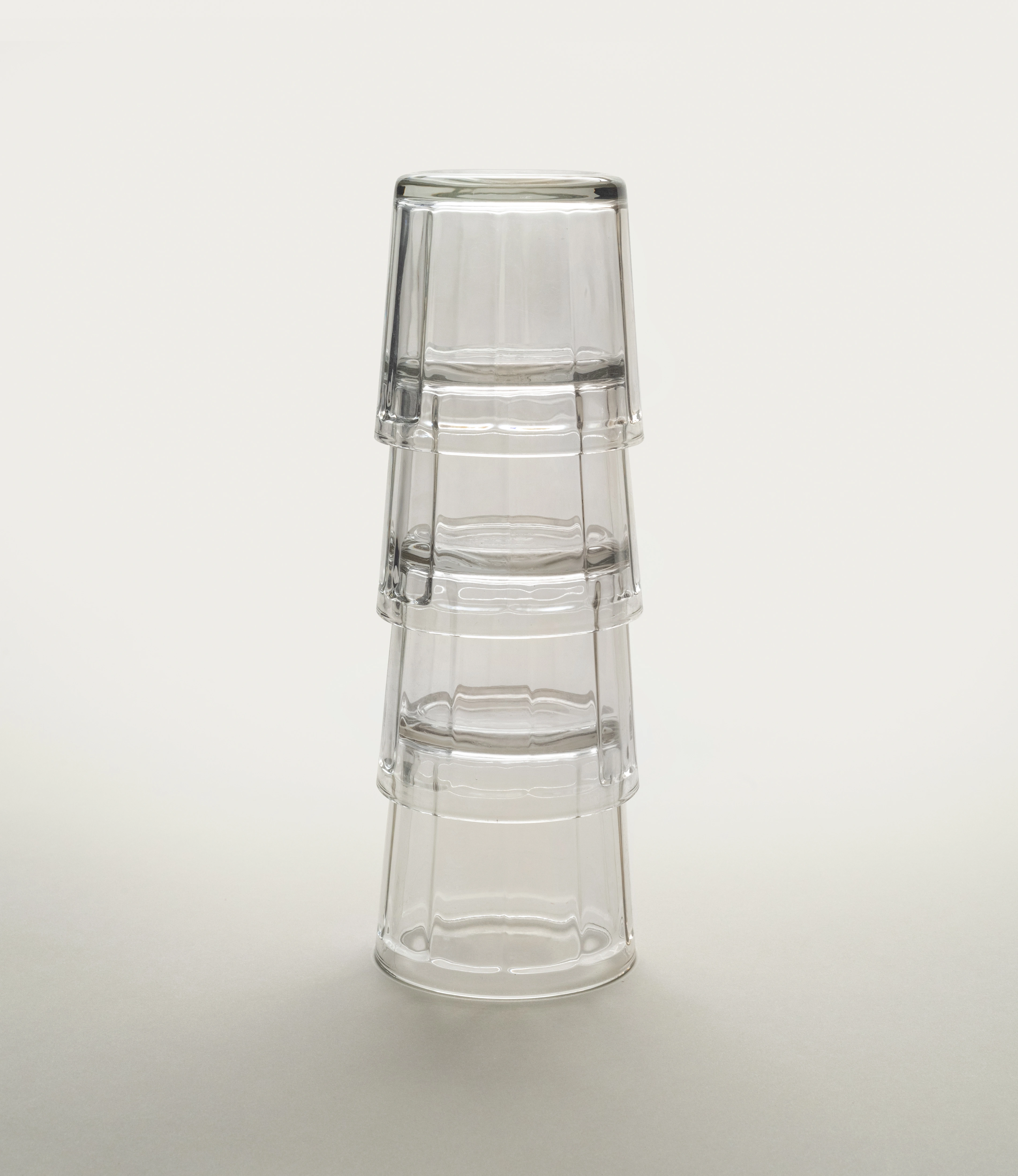 Clear glass tumblers by Serax, featuring a fluted design, displayed on a light neutral background.