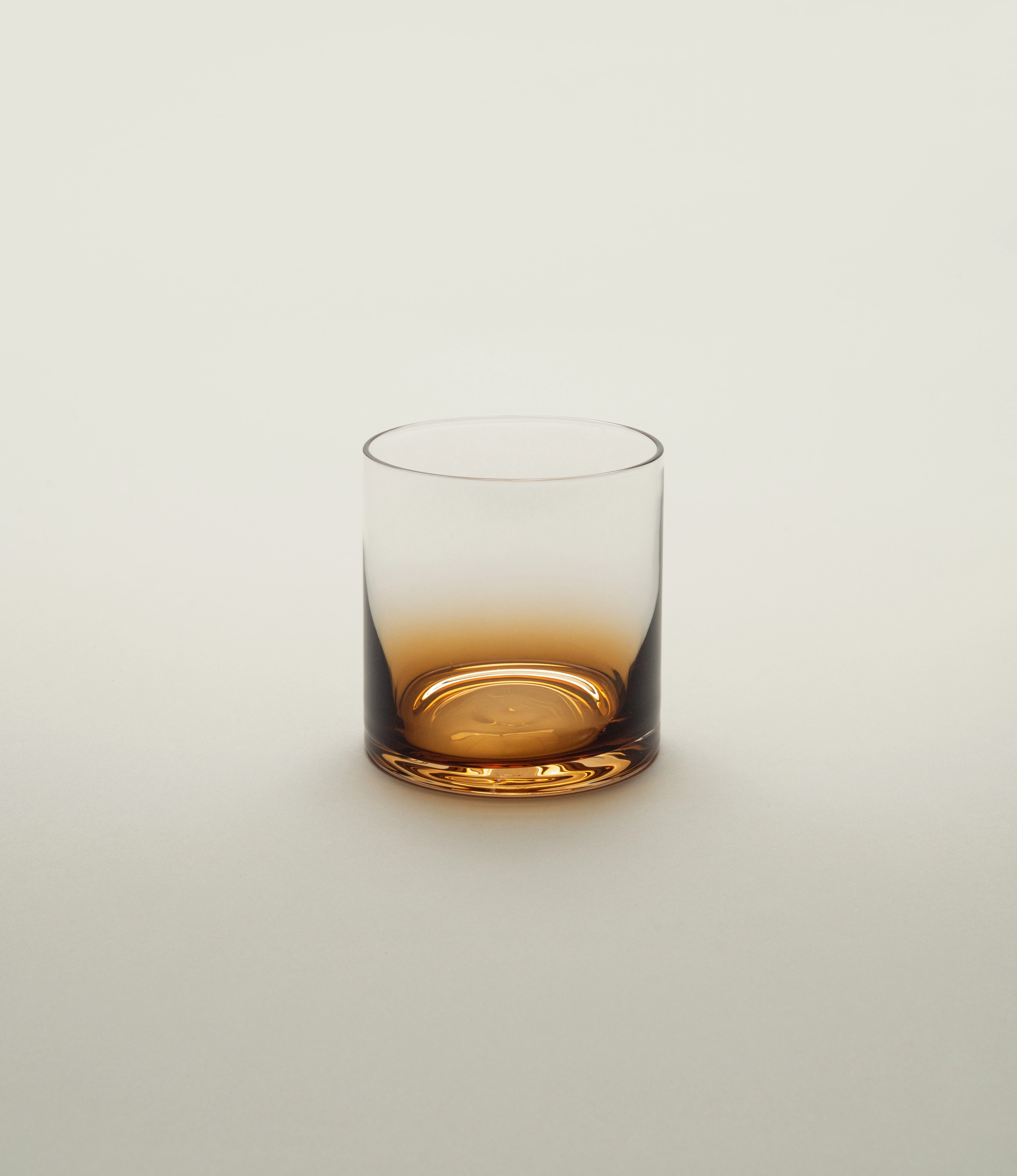 Serax Zuma whiskey glass with a striking amber gradient base, designed for a modern and sophisticated aesthetic, displayed on a soft neutral background.