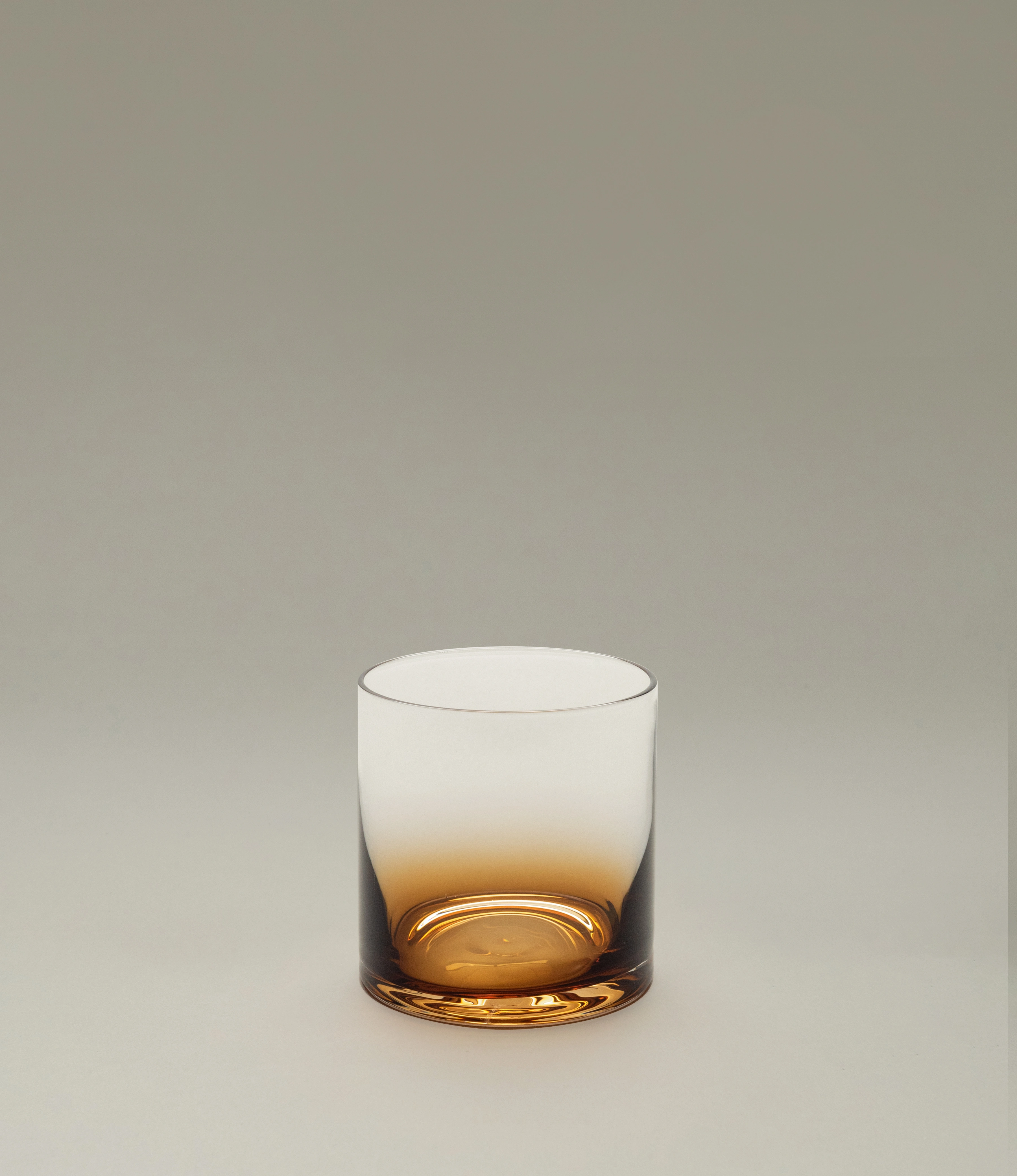Serax Zuma whiskey glass with a striking amber gradient base, designed for a modern and sophisticated aesthetic, displayed on a soft neutral background.