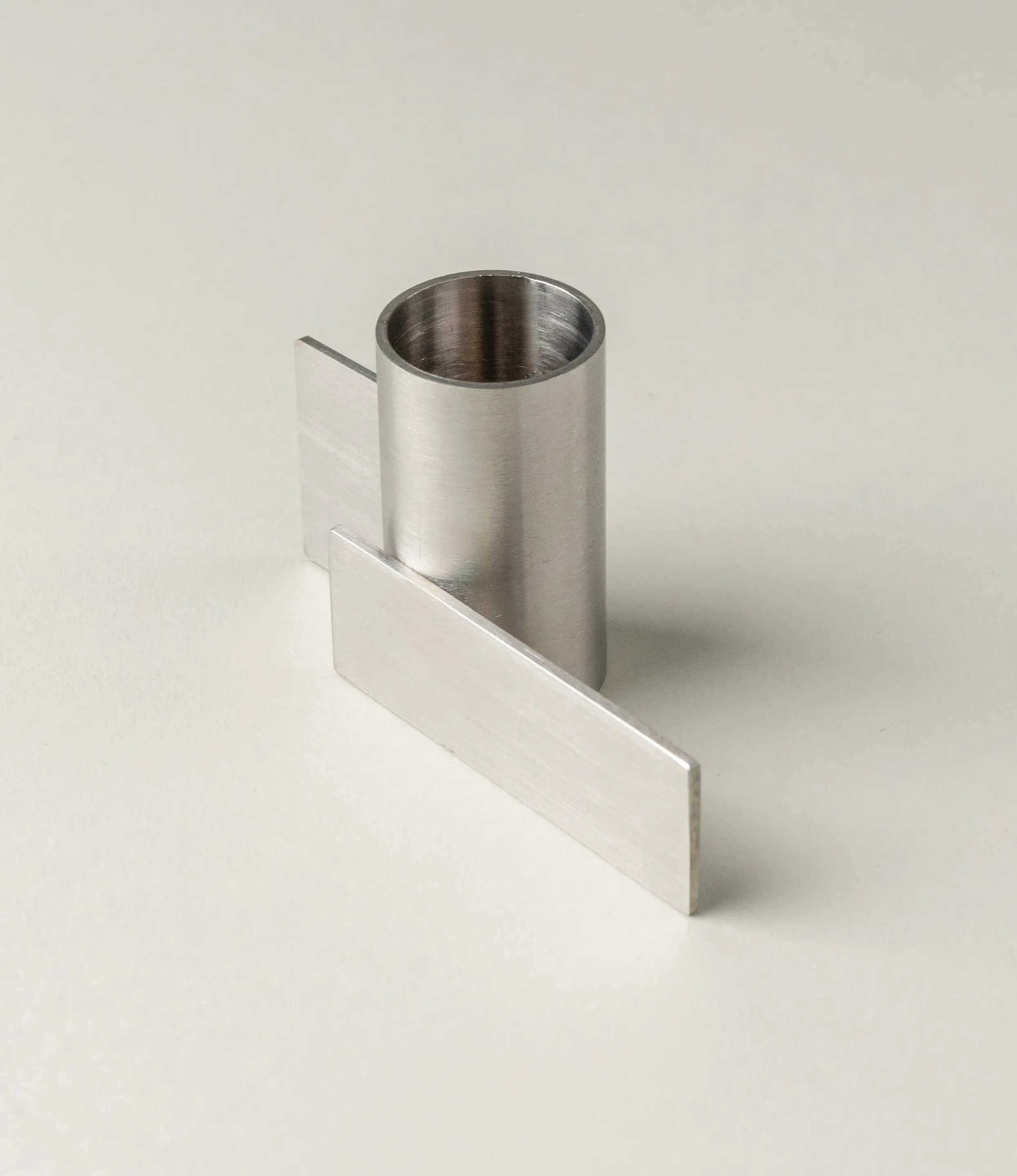 Icon Iysestage 01 from Stences is a candleholder made for taper candles. This picture shows the chrome variant of this item. The steel material has a brushed surface which emphasize the soft geometric shapes of the product in question.