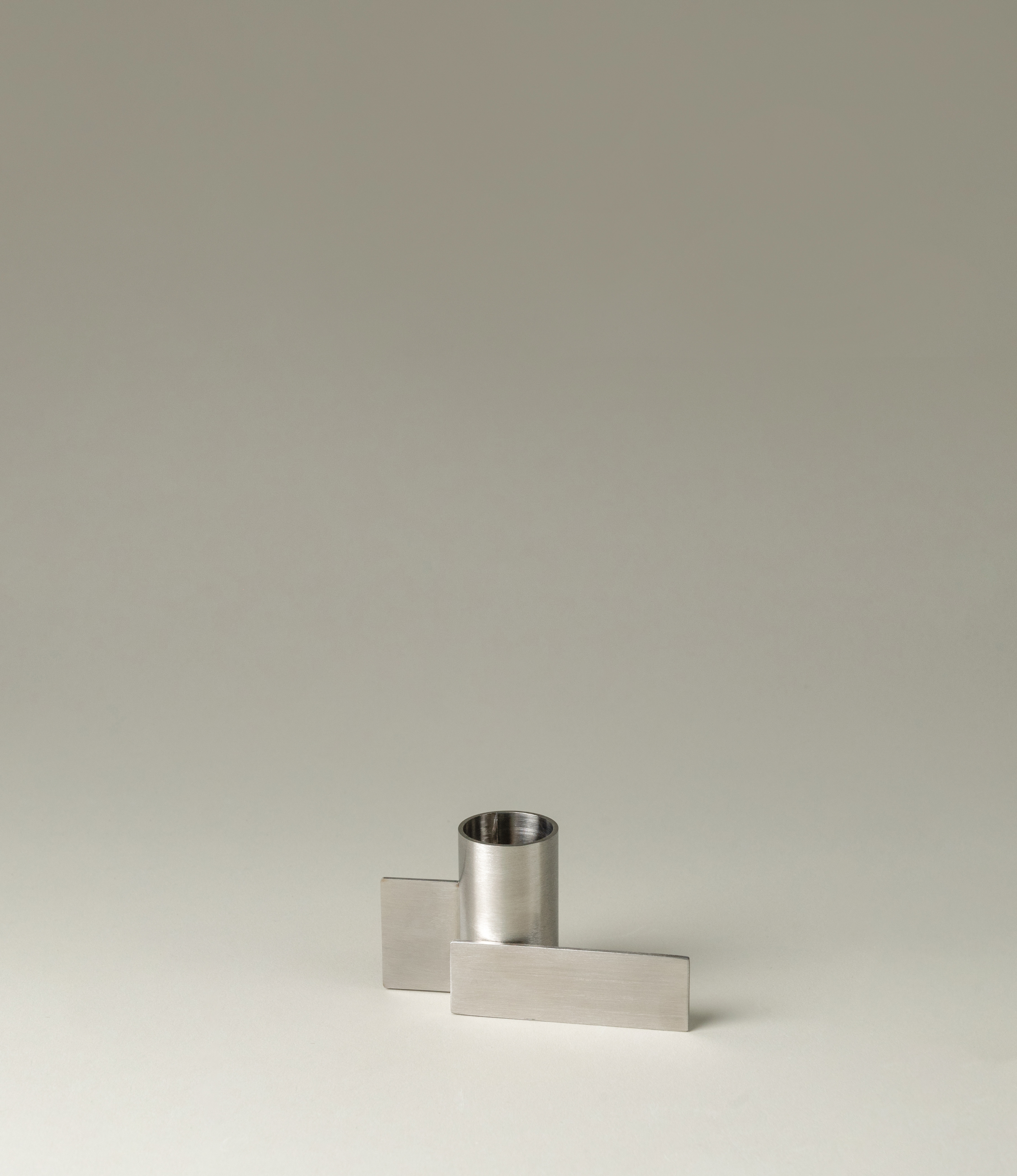 Icon Iysestage 03 from Stences is a candleholder made for taper candles. This picture shows the chrome variant of this item. The steel material has a glossy surface which emphasize the soft geometric shapes of the product in question.