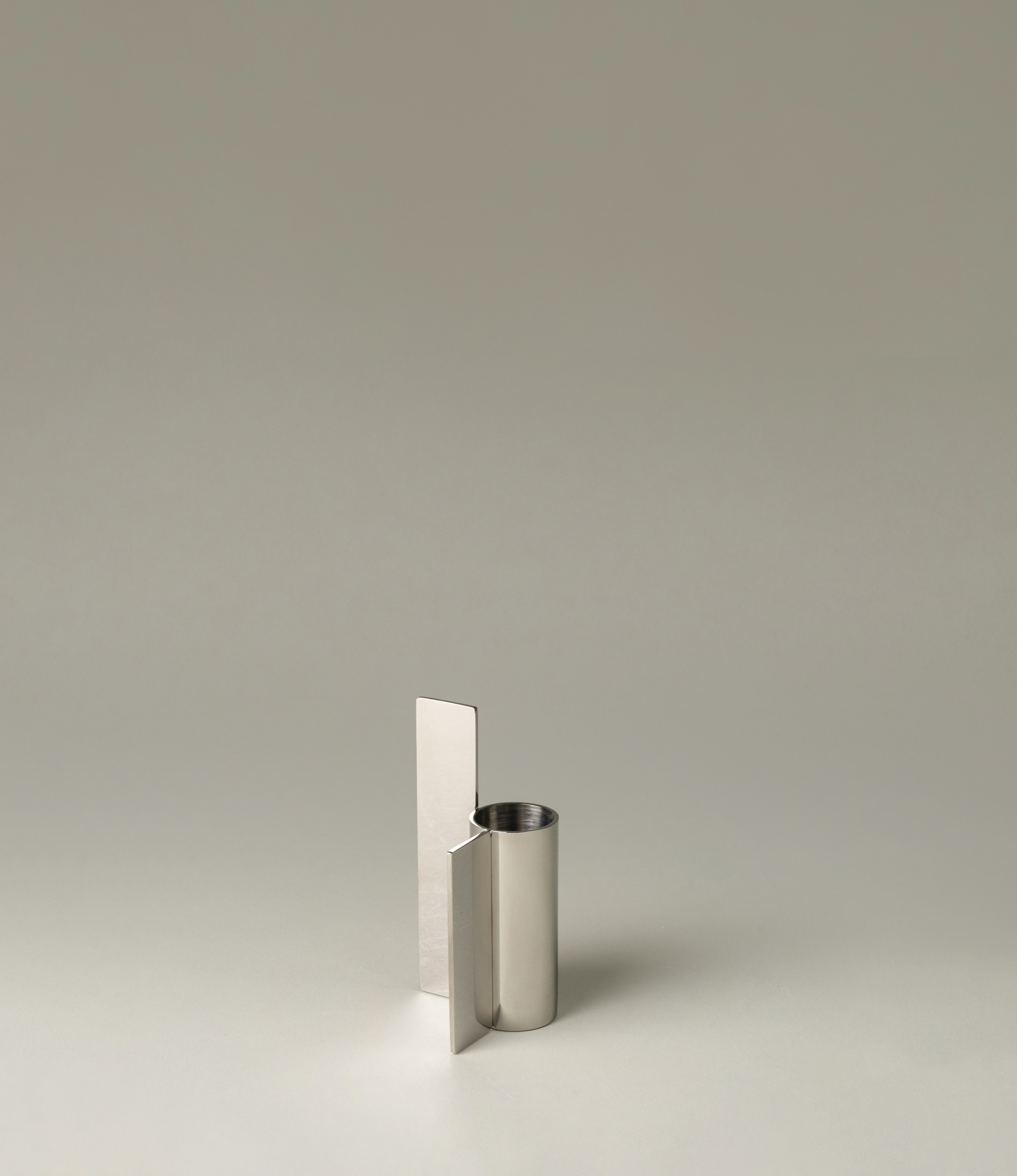 Icon Iysestage 03 from Stences is a candleholder made for taper candles. This picture shows the chrome variant of this item. The steel material has a glossy surface which emphasize the soft geometric shapes of the product in question.