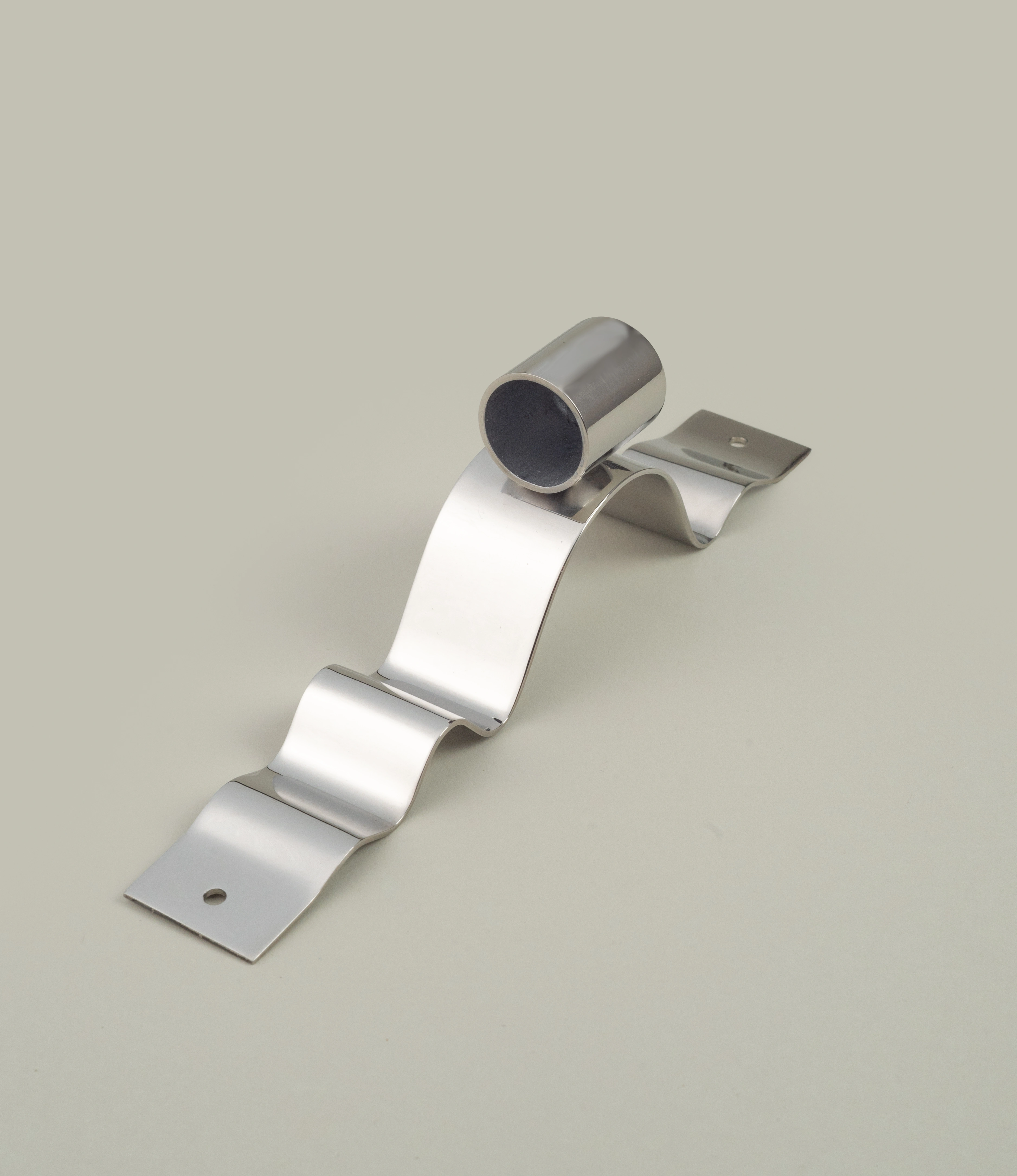 Wave Wall Candle Holder from Stences is ment to be hanged on your wall. The polished stainless steel item is attached to your wall with the ribbon-like wavy chrome part behind the part that holds your taper candle.