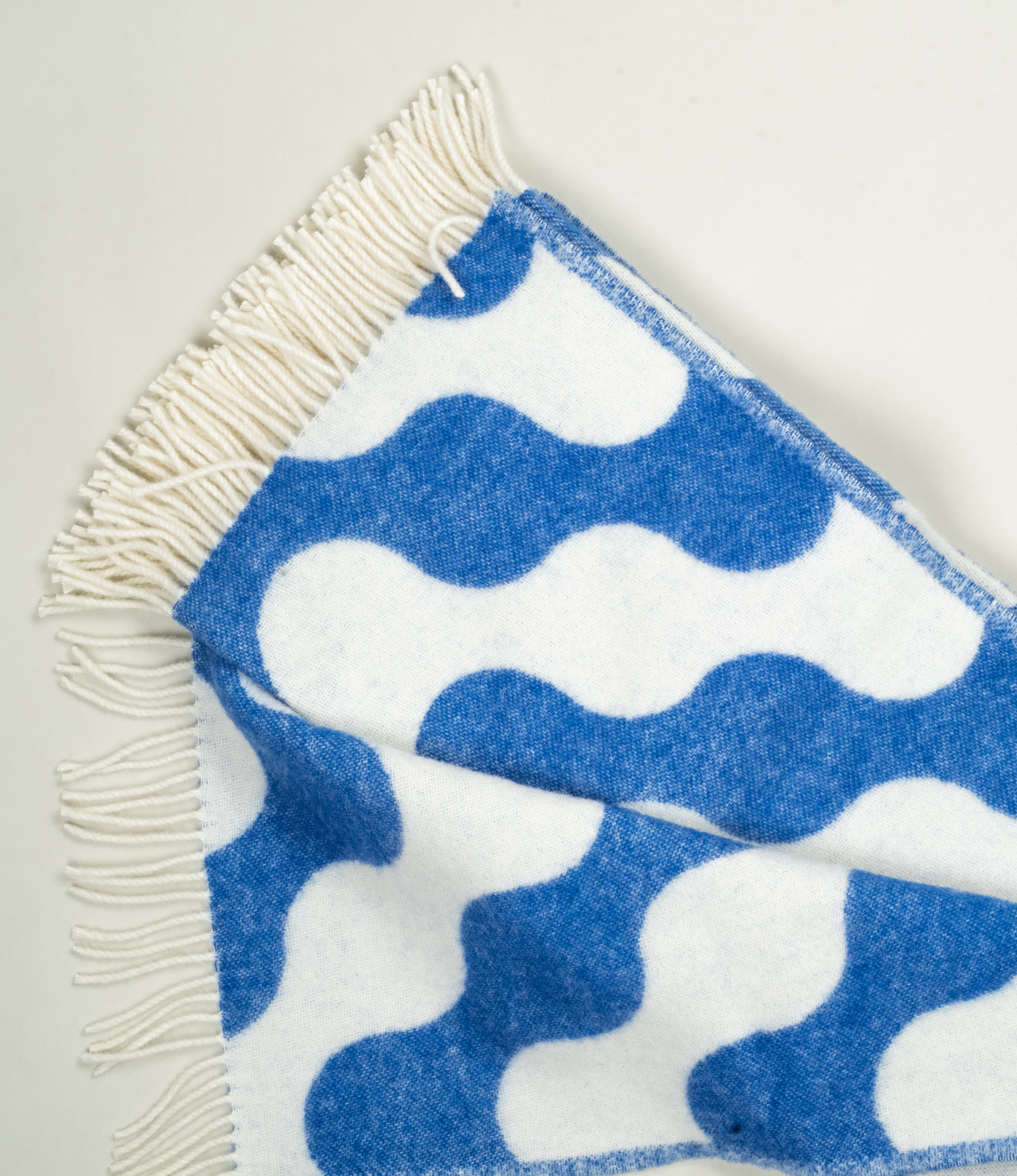 Medusa Blanket partially unfolded – Showcasing the full pattern of organic curves and its generous size.