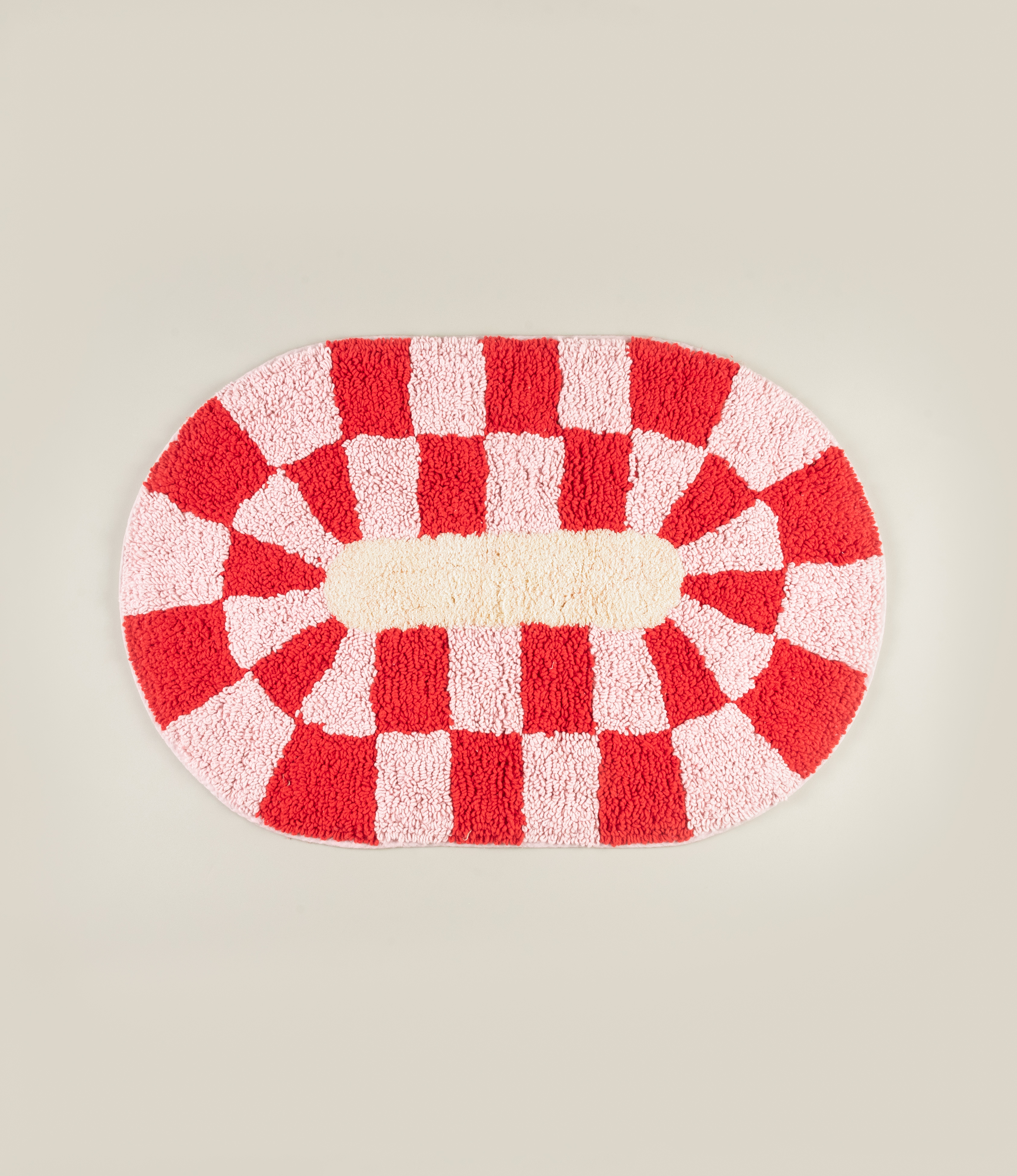 Miranda Bathmat by Tarta Gelatina, featuring a bold red and pink checkered pattern with a soft cream center, made from 100% cotton.