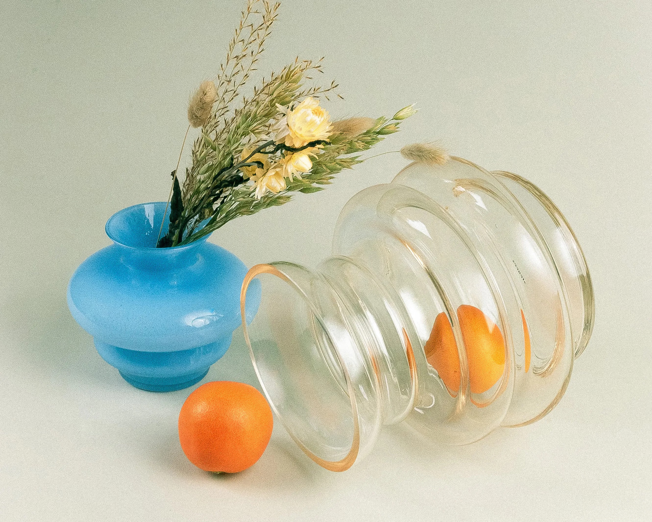Two curve vases from Stences, and dried flower bouquet in a natural color hue.
