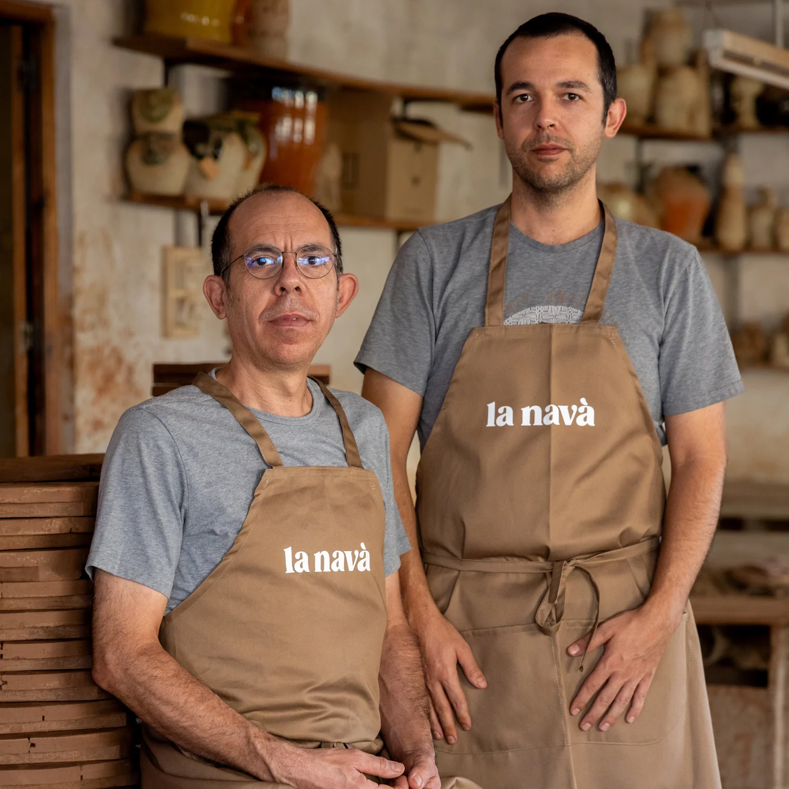 Founders of La NAVA alfareria posing in their ceramic studio