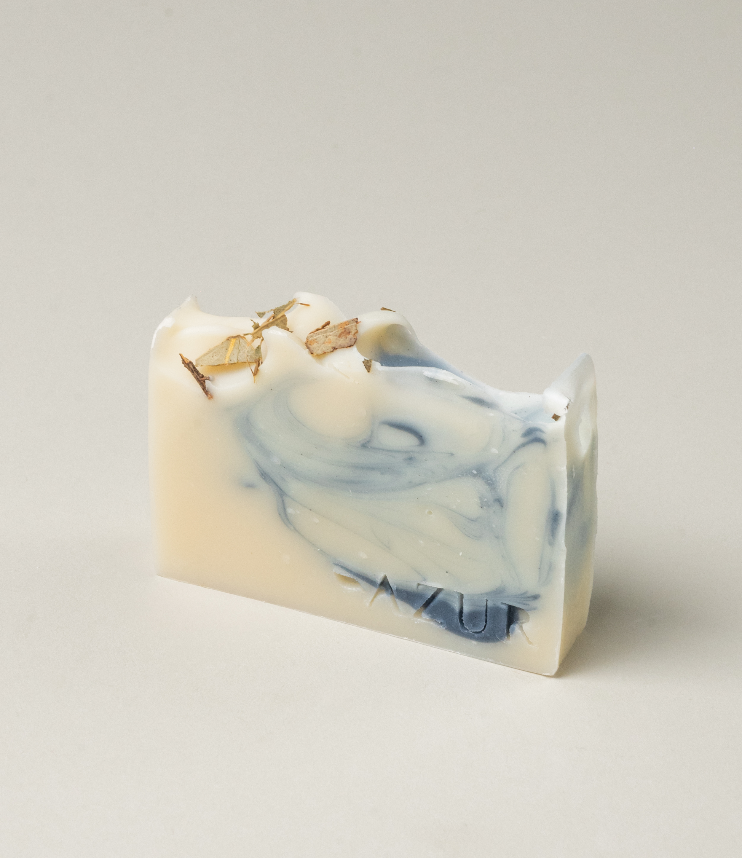 Mighty Mint Natural Soap from Azur Natural BodyCare. It's color vary from vanilla to medium blue. The top of this handmade soap is sprinkled with the ingredients of the item.