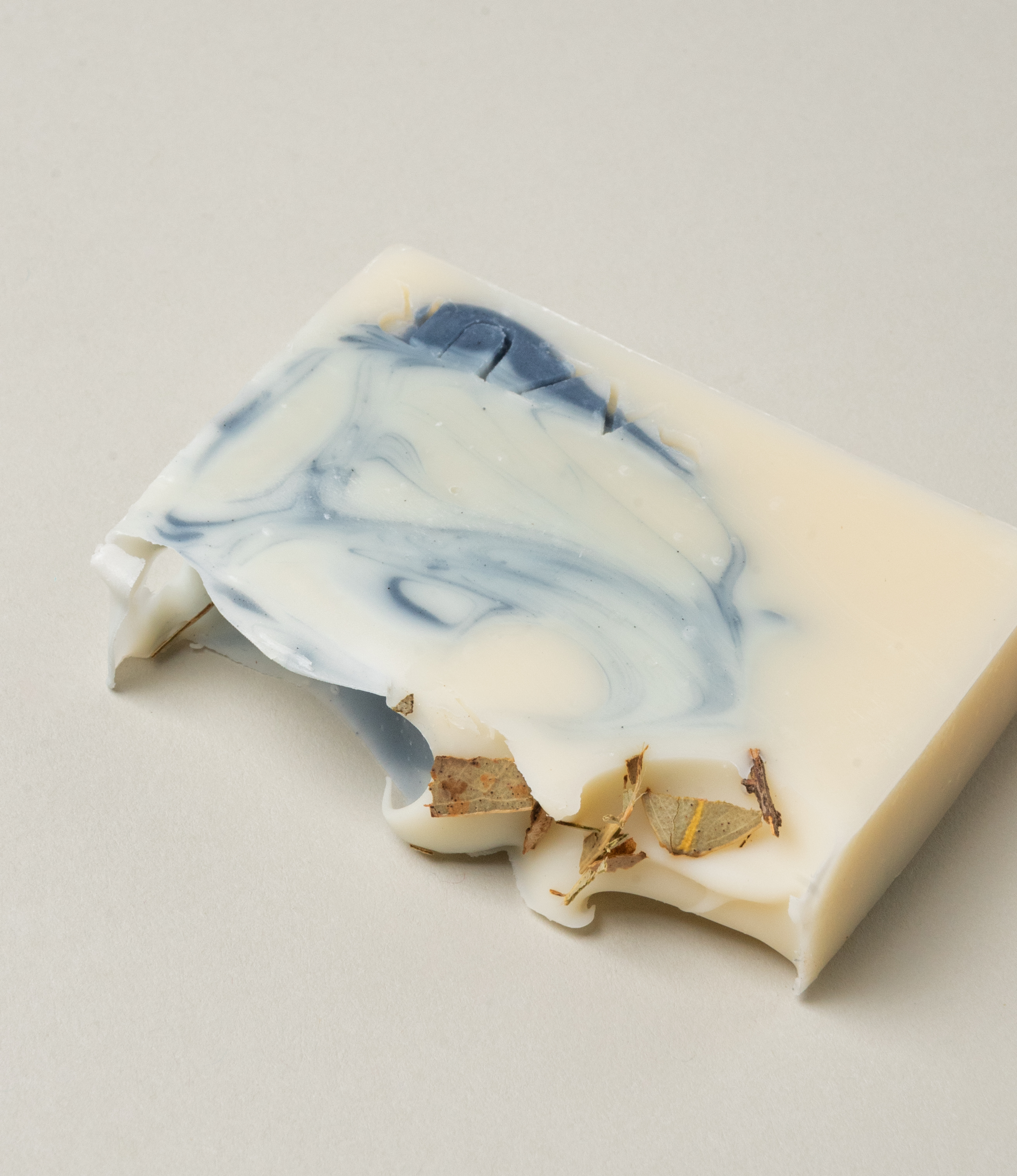 Mighty Mint Natural Soap from Azur Natural BodyCare. It's color vary from vanilla to medium blue. The top of this handmade soap is sprinkled with the ingredients of the item.