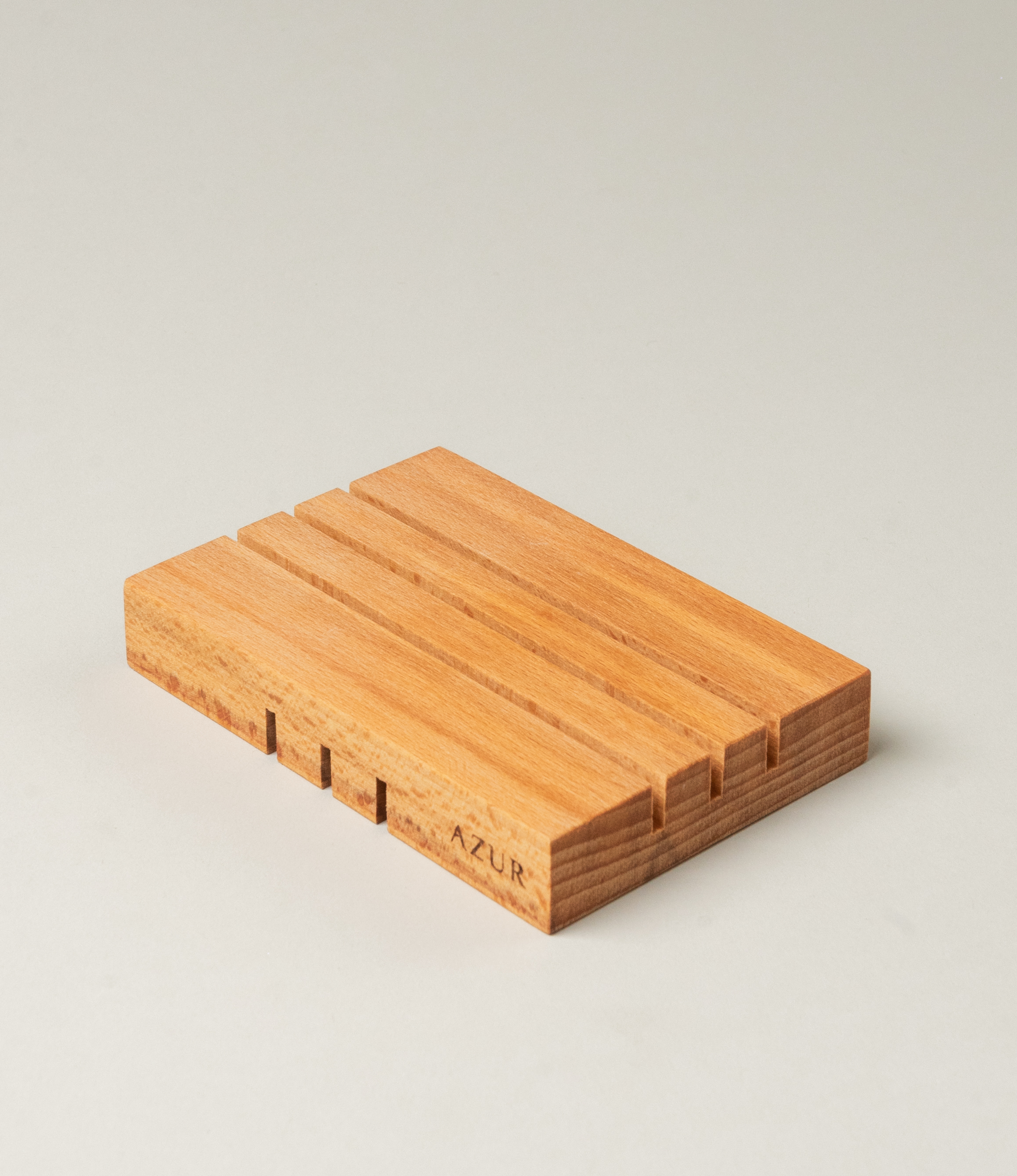 Wooden Soap tray from Azur Natural Bodycare. The item evokes the japanese minimalism with its simple yet sophisticated shape. The Tray has three split on it on both sides, but on the different direction.