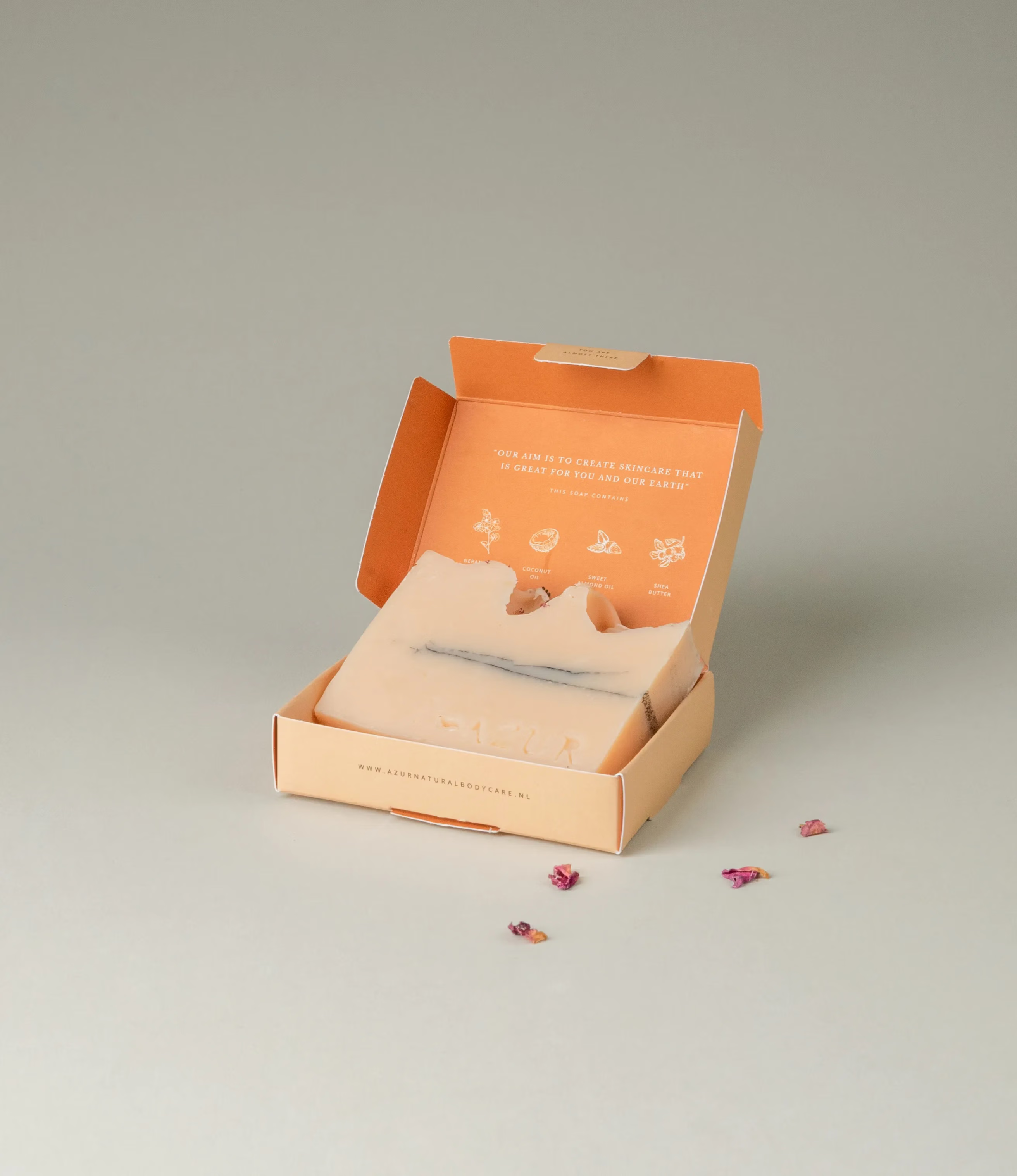 This soap has the scent of Wild Flower and it was crafted by Azur Natural Bodycare. The product merges two colors, light peach and dark grey. The top of the soap looks like the waves of the ocean and is hinted with petals.