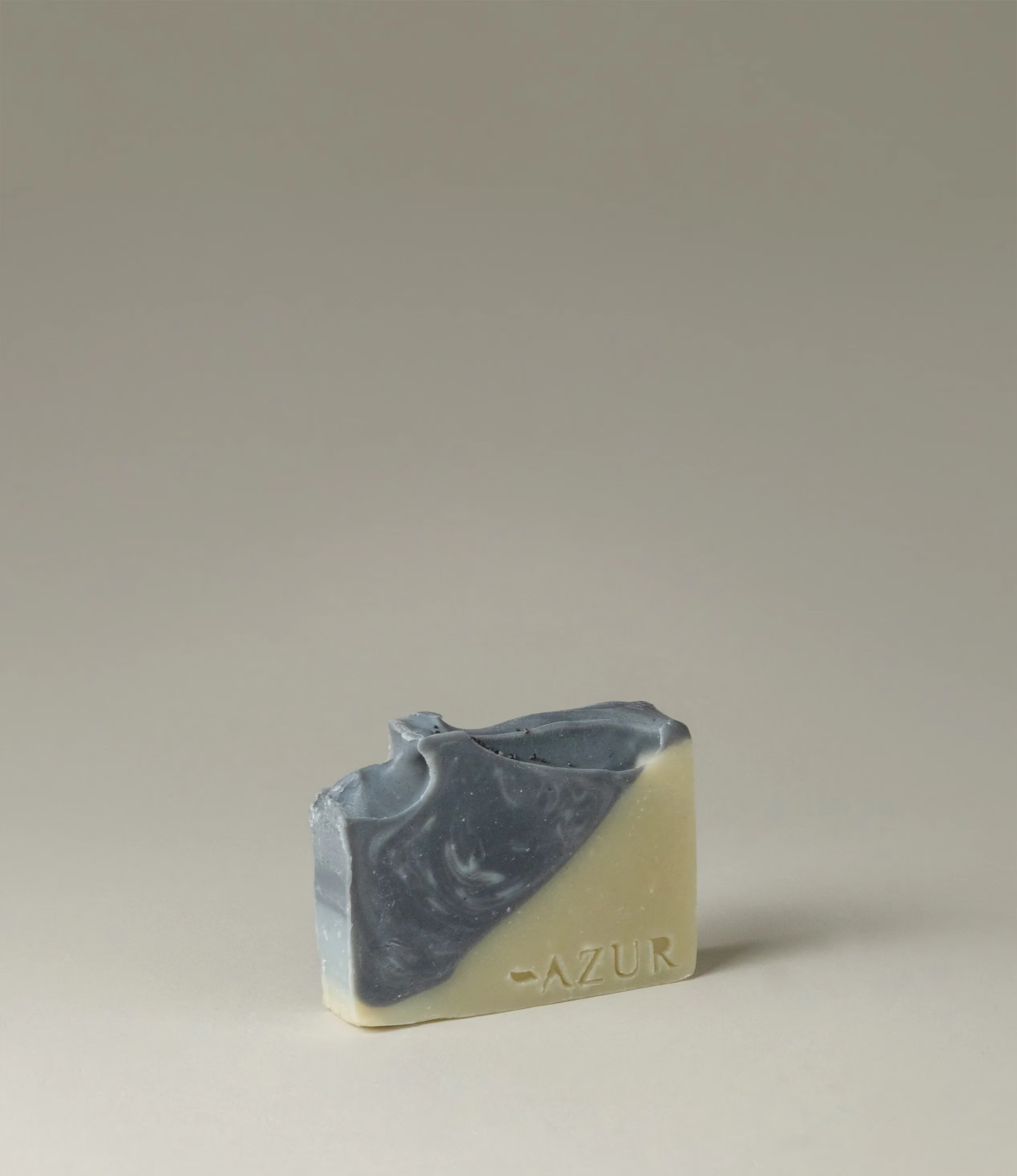 This soap has the scent of Wild Woods and it was crafted by Azur Natural Bodycare. The product merges two colors, light olive and dark grey. The top of the soap looks like the waves of the ocean.