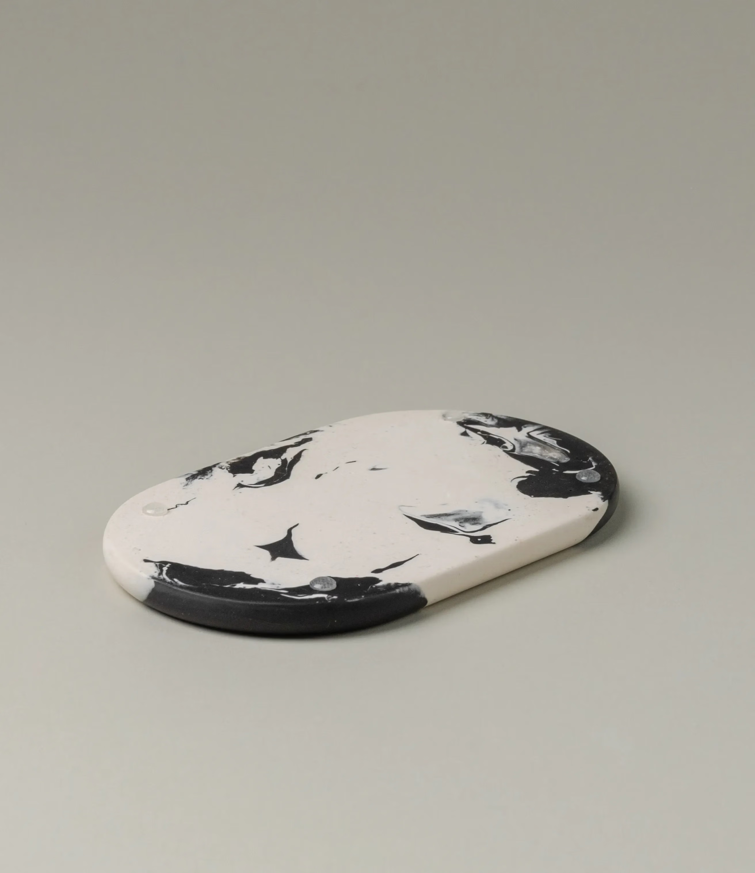 Soap dish from Gritful in a monochrome black and white color. The item has a rounded shape, fits perfectly with our soaps from Azur Natural Bodycare. This picture shows the bottom of the product.