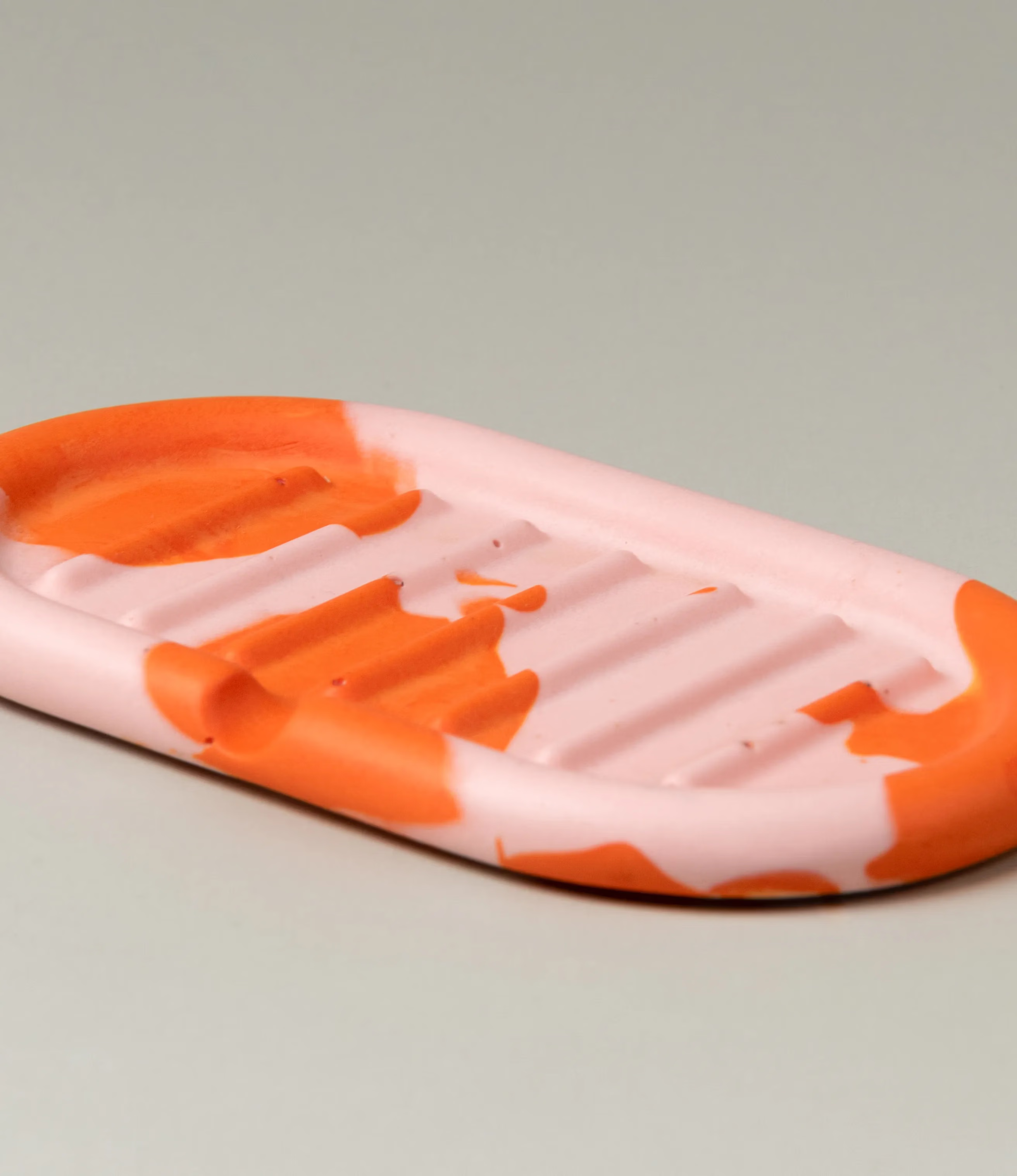 Soap Holder from Gritful Homeware in the maximalist color pairing of light rose and orange. The soap dish has a rounded shape which matches the pattern of the item, which is very much organic. 