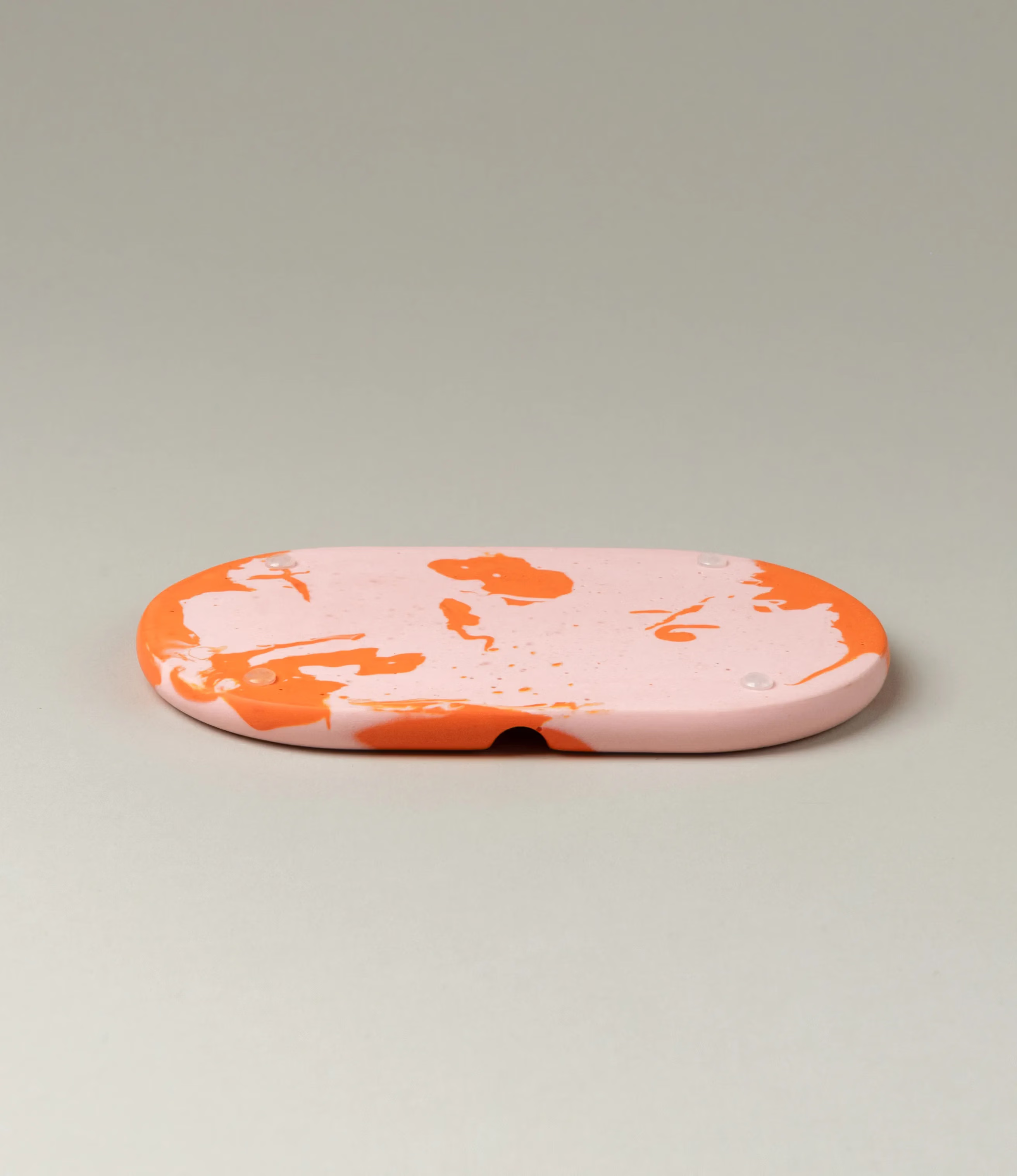 Soap Holder from Gritful Homeware in the maximalist color pairing of light rose and orange. The soap dish has a rounded shape which matches the pattern of the item, which is very much organic. 