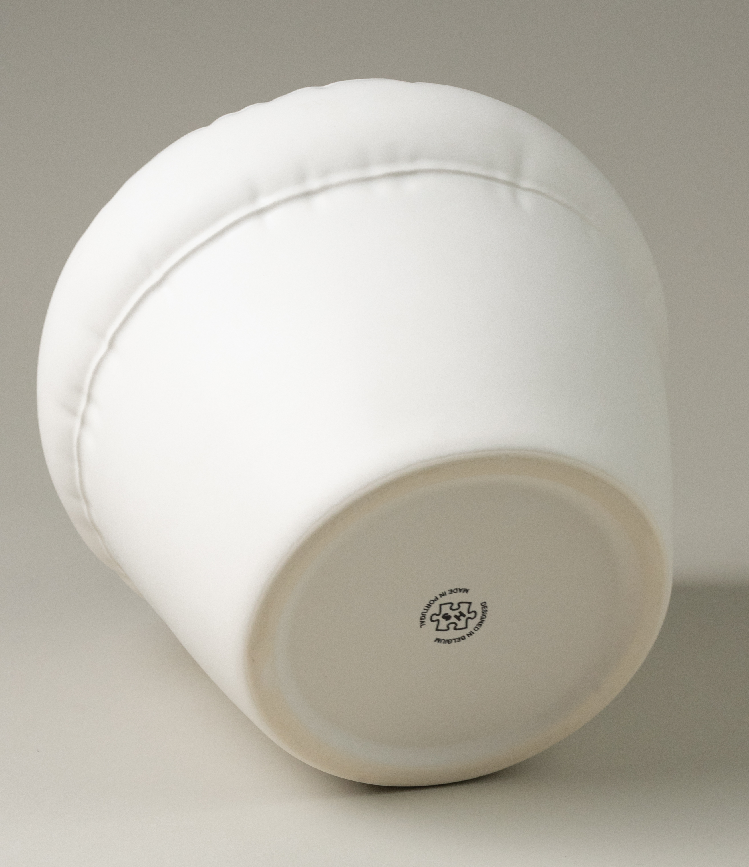 The bottom of Homestudyo's planter Pierre in Bone (white)  color.  the planter design looks like and inflatable ballon although it is made of ceramics.