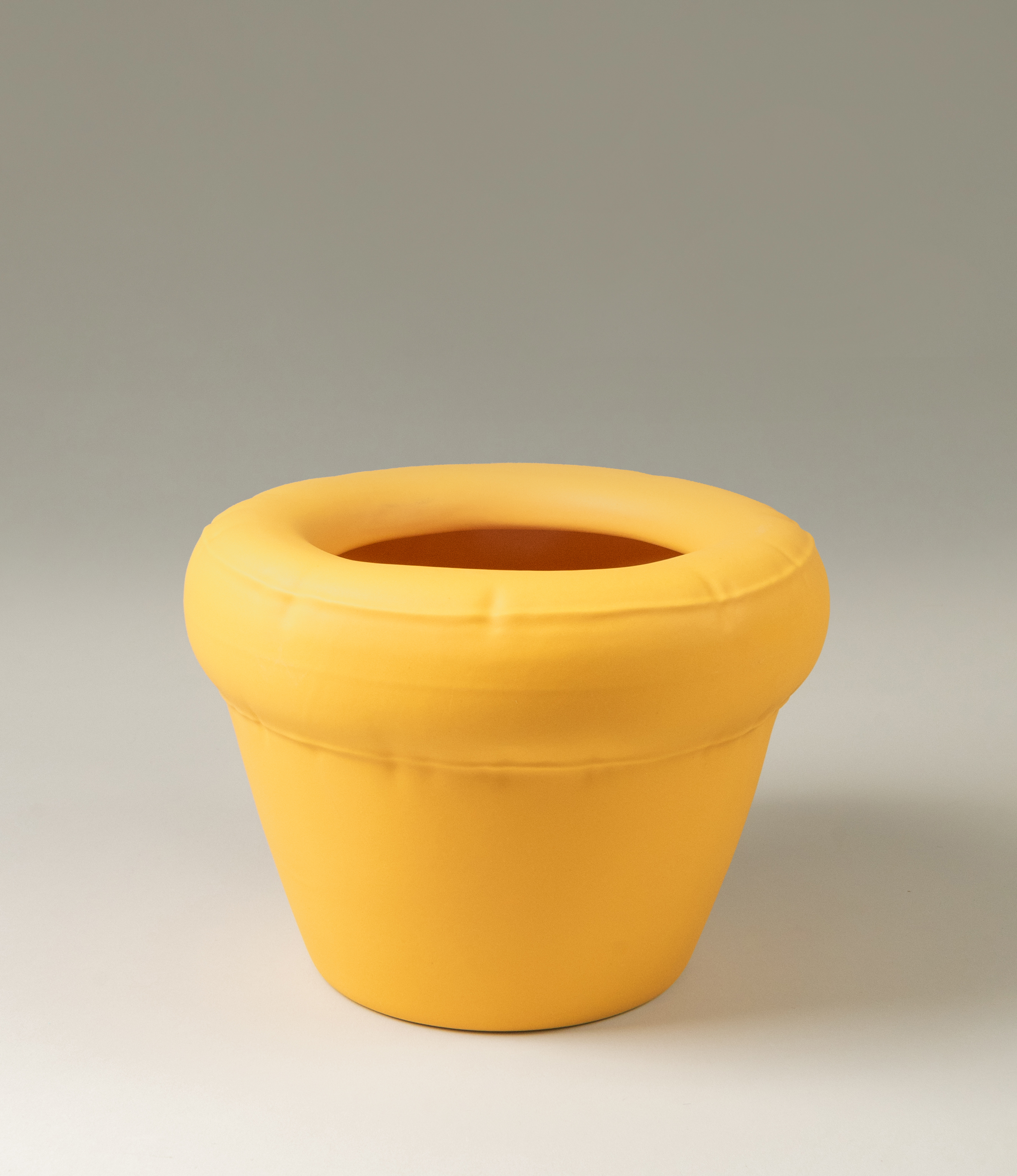 Homestudyo planter pierre in Yolk (yellow) color. The perpective of the shot is a zoom. the planter design looks like and inflatable ballon although it is made of ceramics. Perfect addition for any maximalist interior