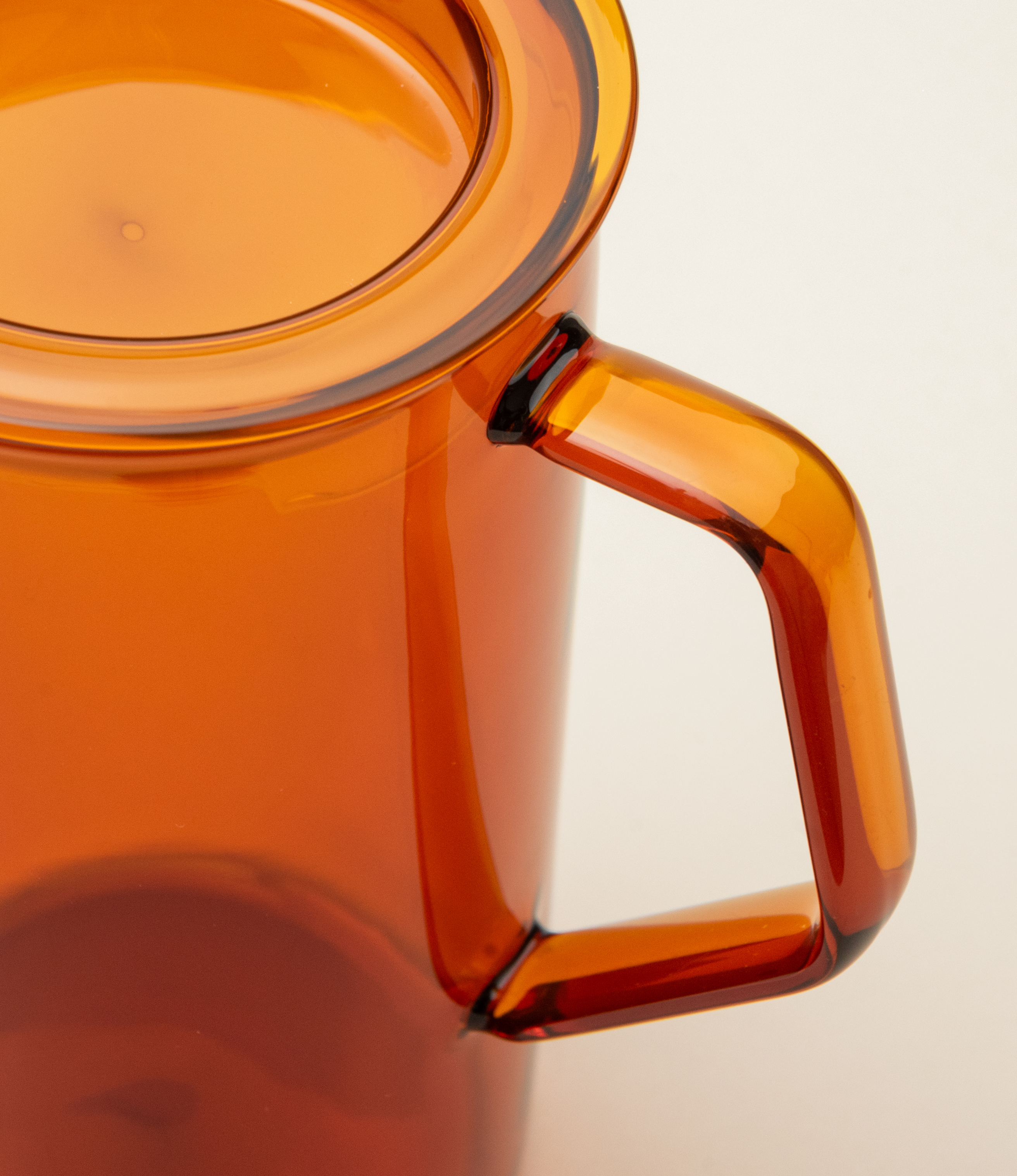 Cast Amber Jug from Kinto. The Item can hold 750ml of liquid. The modern geometric shape is a perfect companion to any kitchen.