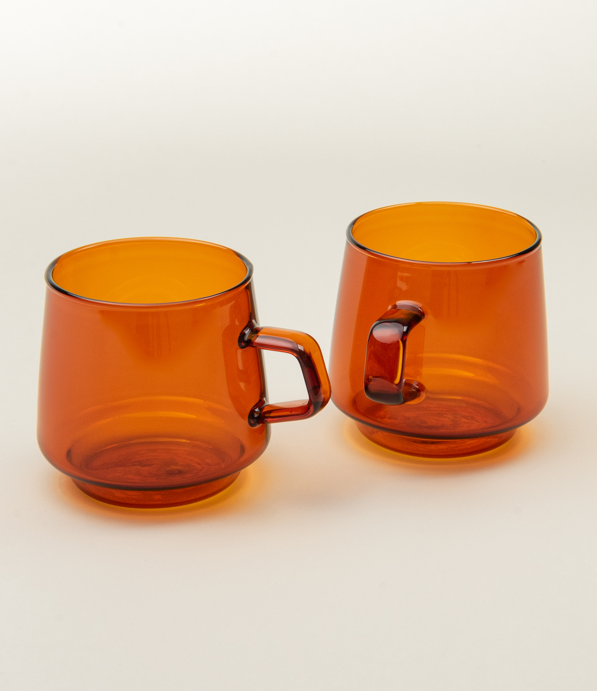 Sepia Mug is a glass mug from the japanese brand Kinto. The item is coming in the popular amber color which fits well the nostalgic shape of the product. The product has a small handle on the side.