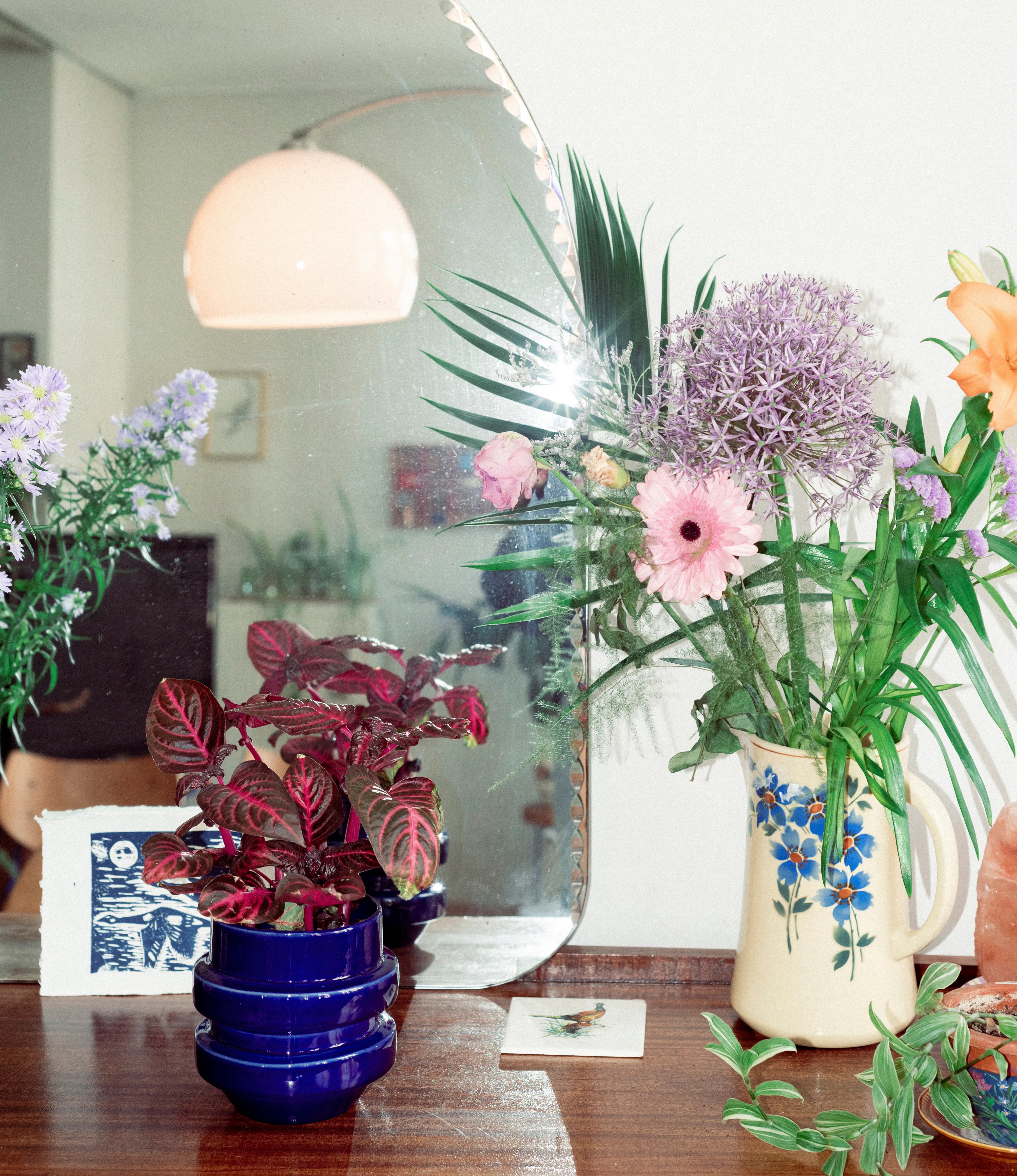 NW Buoy Planter from Nova Casa Atlantica showcased on top of a drawer, with vintage vases and flowers. In the background there is a 80's geometric lamp.