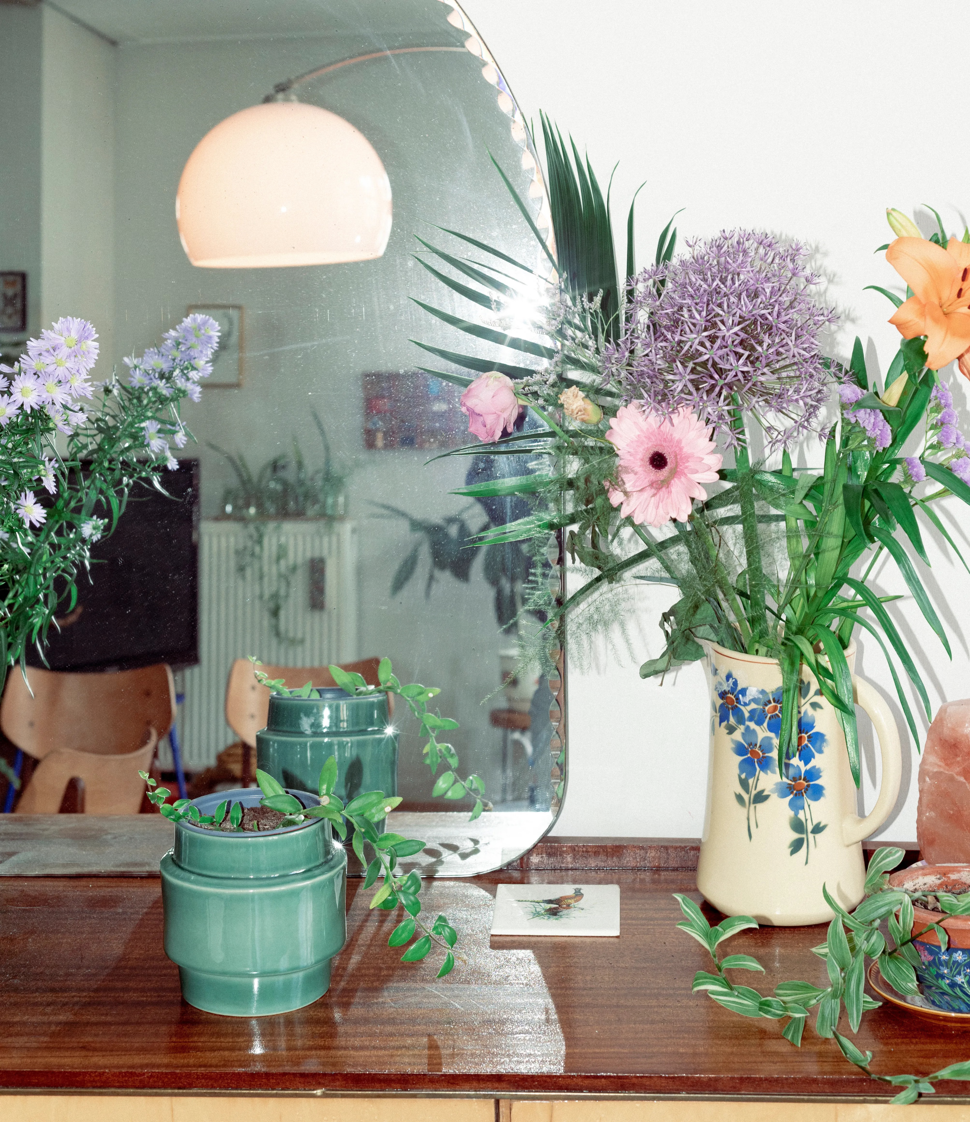 NE Buoy Planter from Nova Casa Atlantica showcased on top of a drawer, with vintage vases and flowers. In the background there is a 80's geometric lamp.