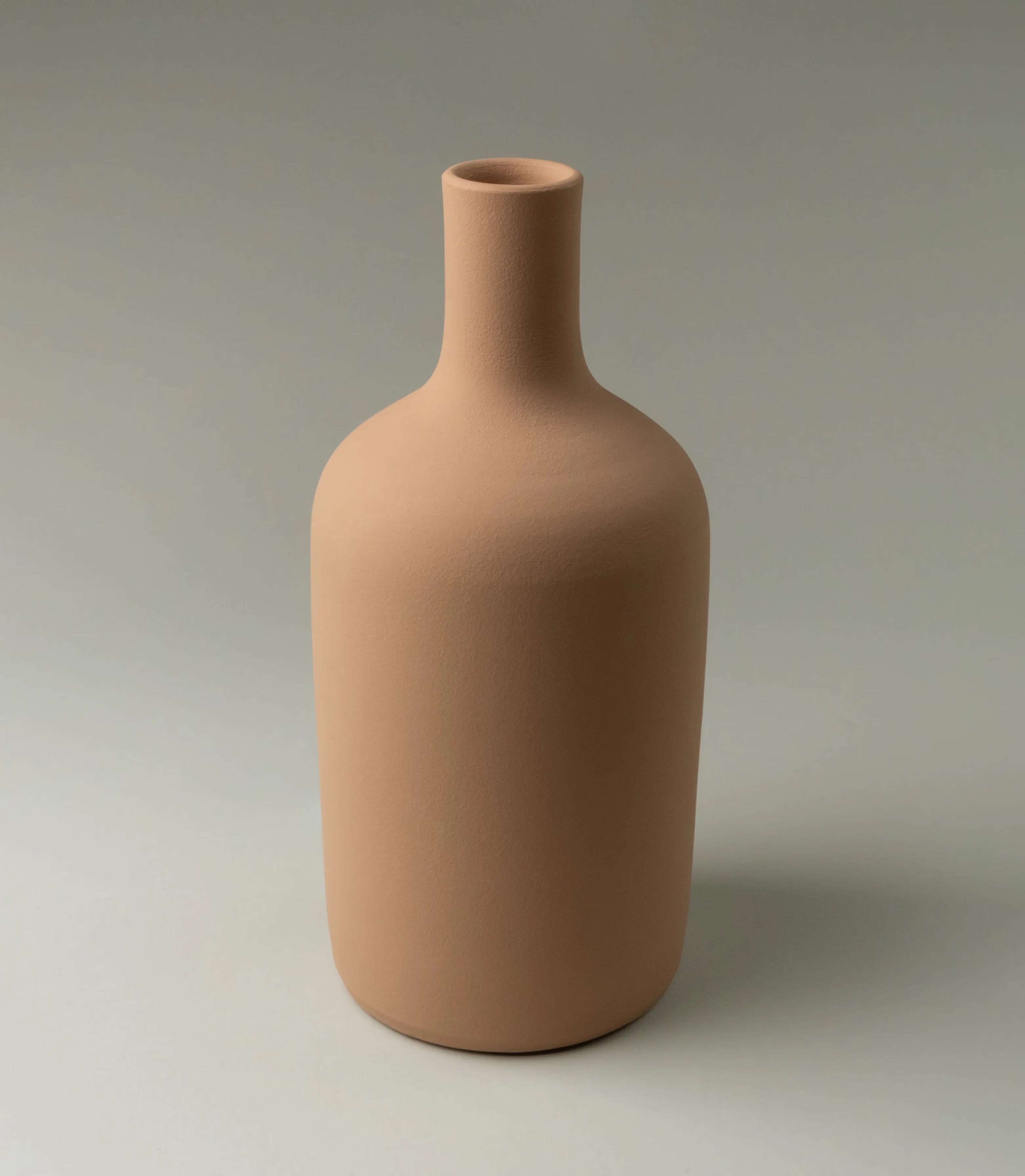 This Beige Vase from Ocactuu has a pure silhouette with a natural beige shade. It is a medium sized vase, perfect for your fresh flowers. The neck of the vase is rather tight thus you can use this piece with only a few branch as well. Perfect choice for a minimalist home, but can balance well other more playful items too.