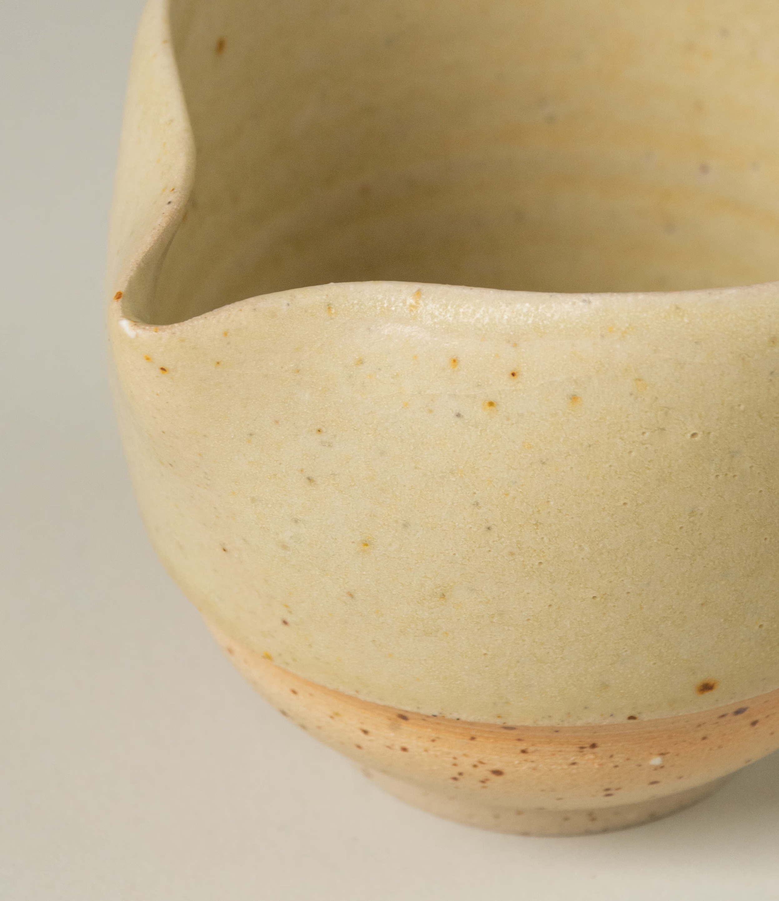 A detail photo of the pourer from Omni Ceramics. You can really feel the human touch on this light beige piece. Handcrafted with an attention to detail.