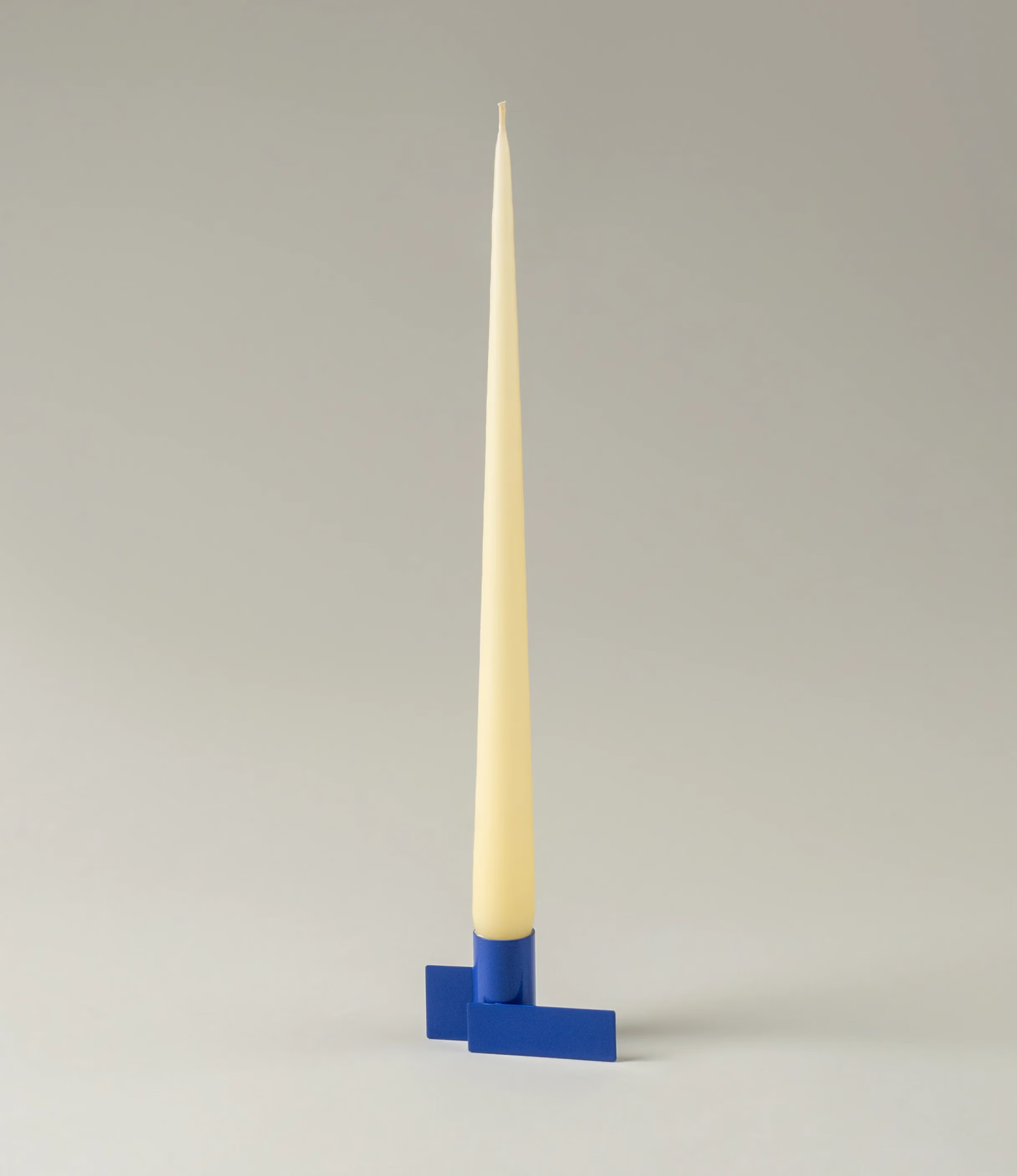 Icon Iysestage 01 is a candle holder from Stences made of steel, painted in blue. The glossy surface of this item emphasize the geometrical shapes of this product. Perfect fit with taper candles. In this picture the item is captured in use with Ester&Erik's Taper Candle in a Buttermilk shade.