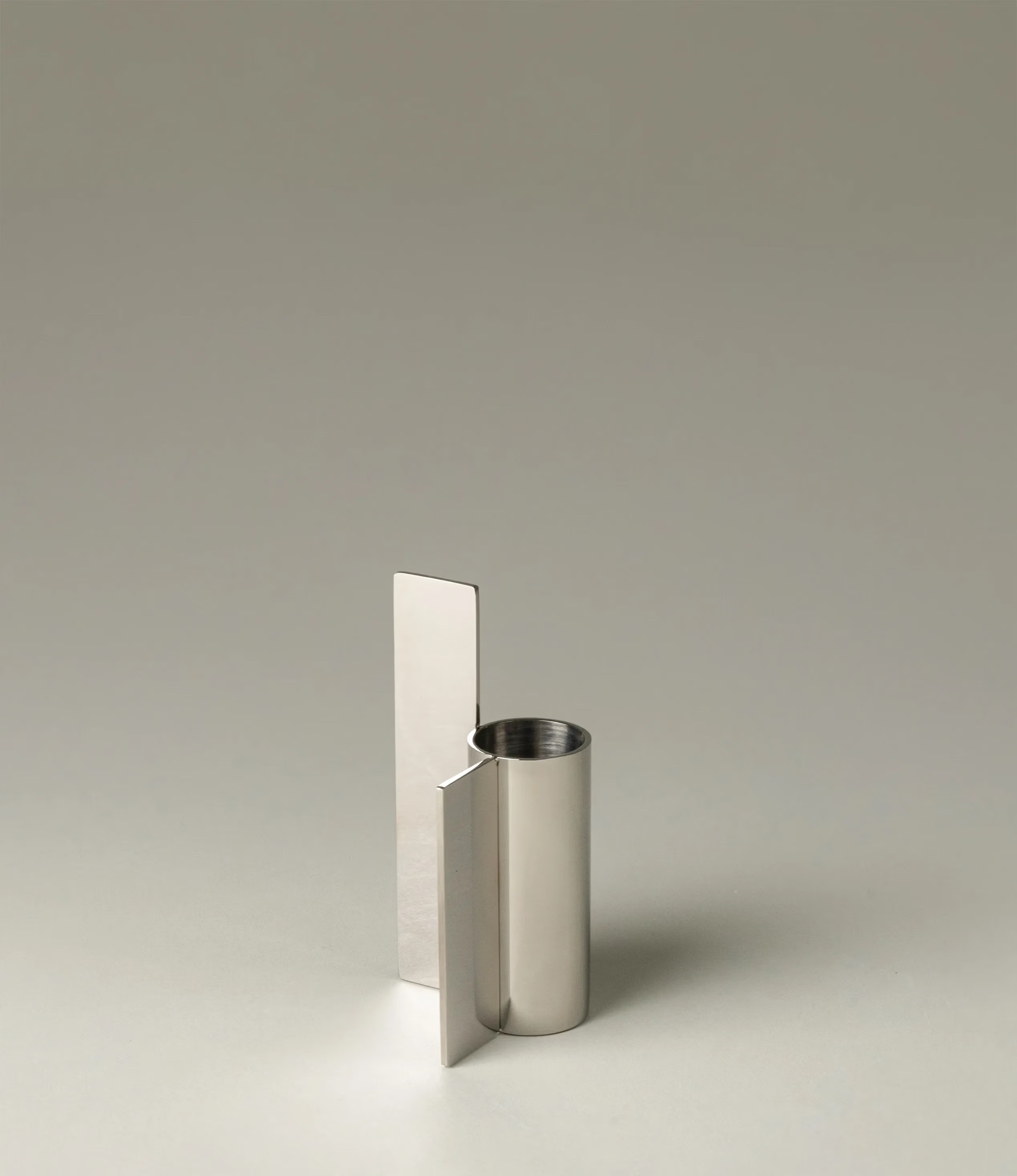 Icon Iysestage 03 from Stences is a candleholder made for taper candles. This picture shows the chrome variant of this item. The steel material has a glossy surface which emphasize the soft geometric shapes of the product in question.