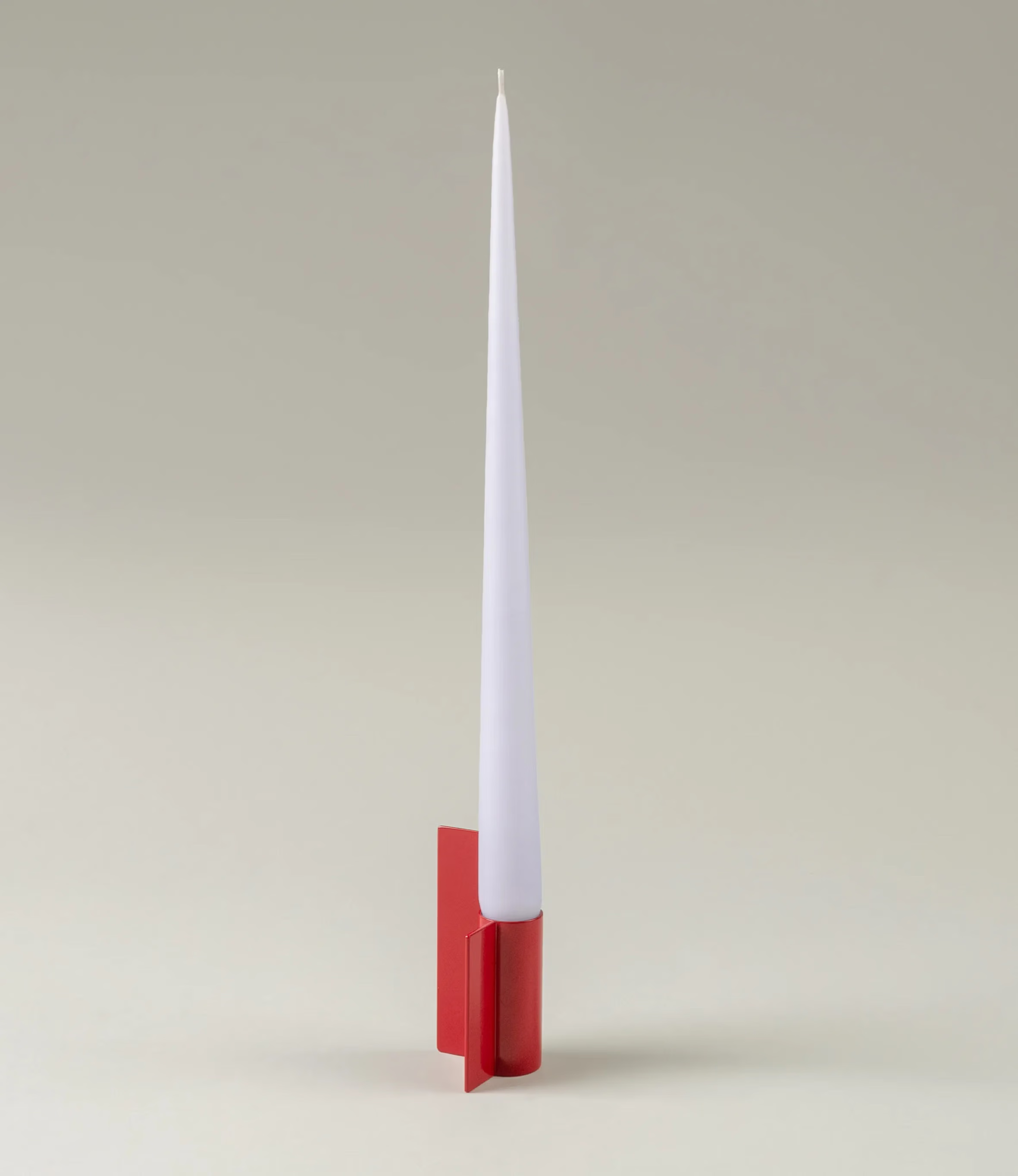 Icon Iysestage 03 from Stences is a candleholder made for taper candles. This picture shows the red variant of this item. The painted steel material has a glossy surface which emphasize the soft geometric shapes of the product in question.