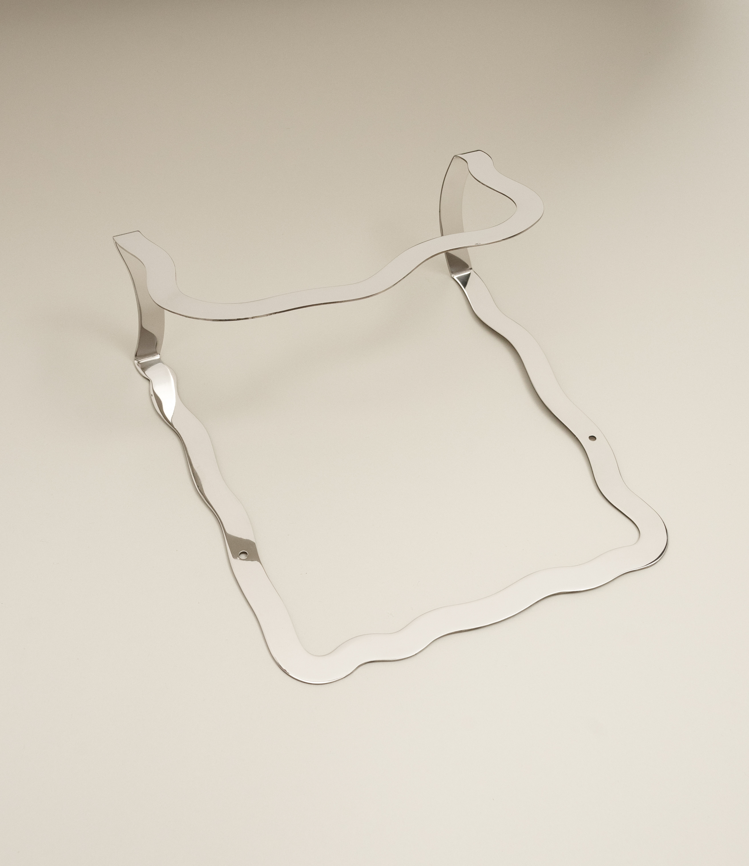 Wave Magazin Holder from Stences. Attach this stainless steel piece to your wall to hold your favorite magazines. The wavy shape makes the brutalist material more adaptable to any style of home.